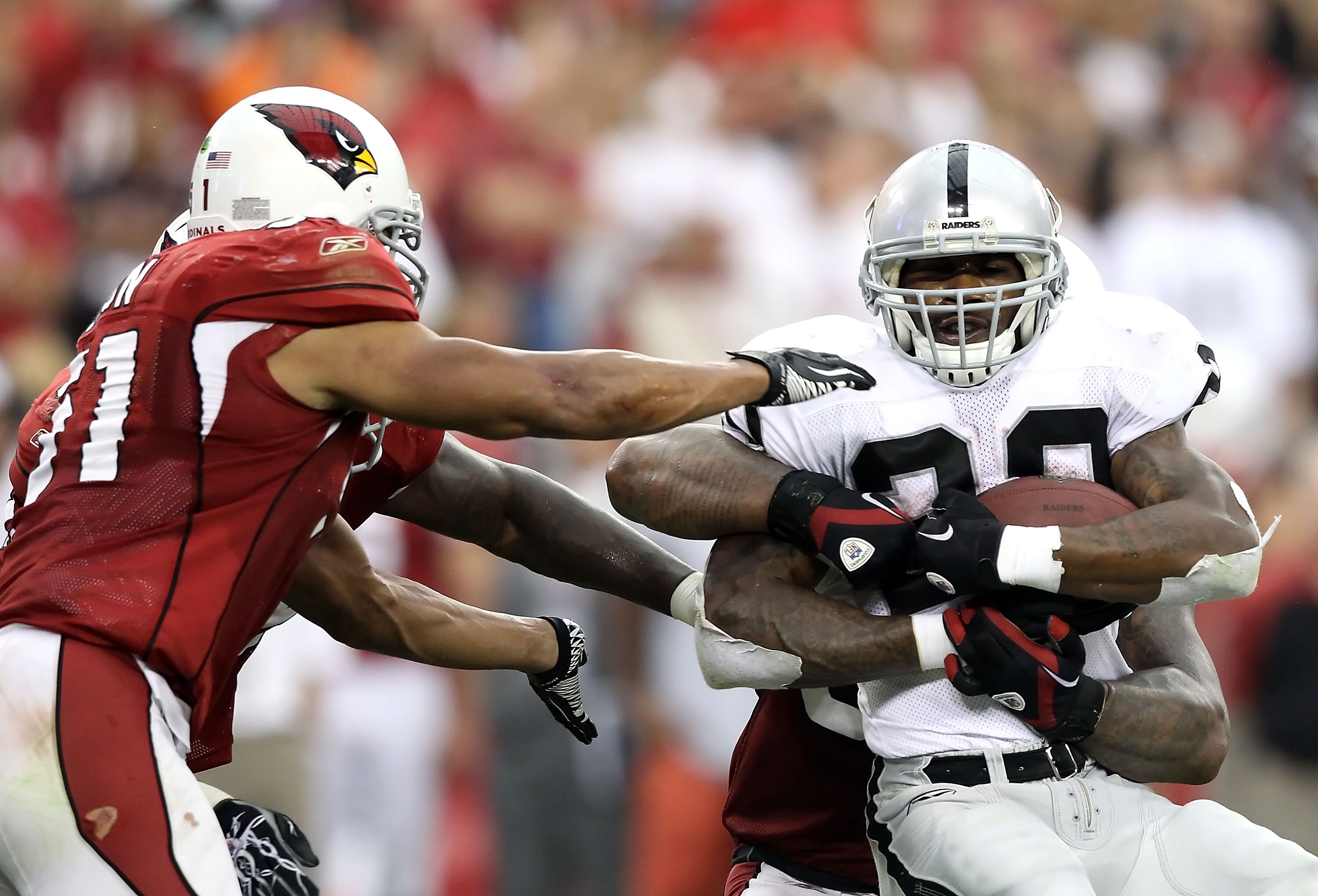 GLENDALE, AZ - SEPTEMBER 26:  Runningback Darren McFadden #20 of the Oakland Raiders rushes the football during the NFL game against the Arizona Cardinals at the University of Phoenix Stadium on September 26, 2010 in Glendale, Arizona.  The Cardinals defe