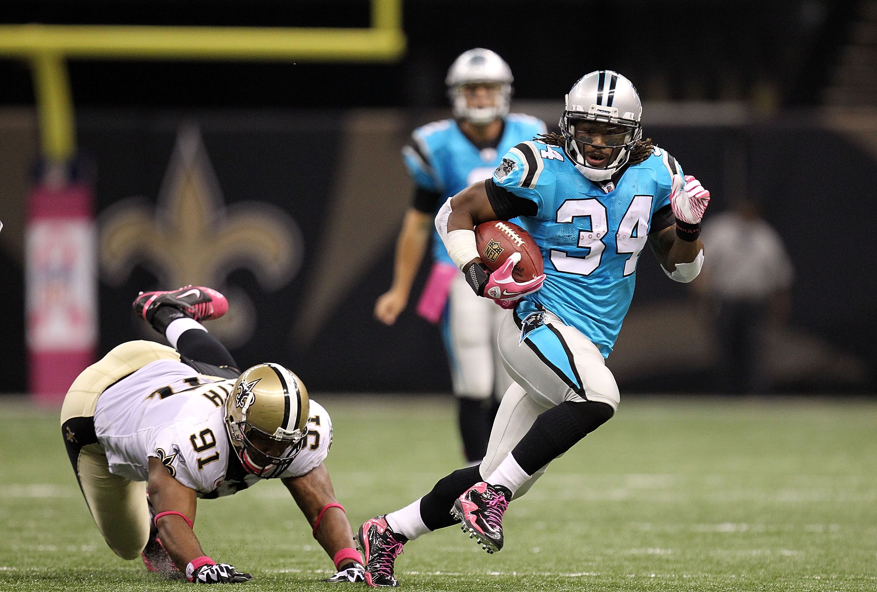 NEW ORLEANS - OCTOBER 03:  Running back DeAngelo Williams #34 of the Carolina Panthers runs for a touchdown past Will Smith #91 of the New Orleans Saints at the Louisiana Superdome on October 3, 2010 in New Orleans, Louisiana.  (Photo by Ronald Martinez/G