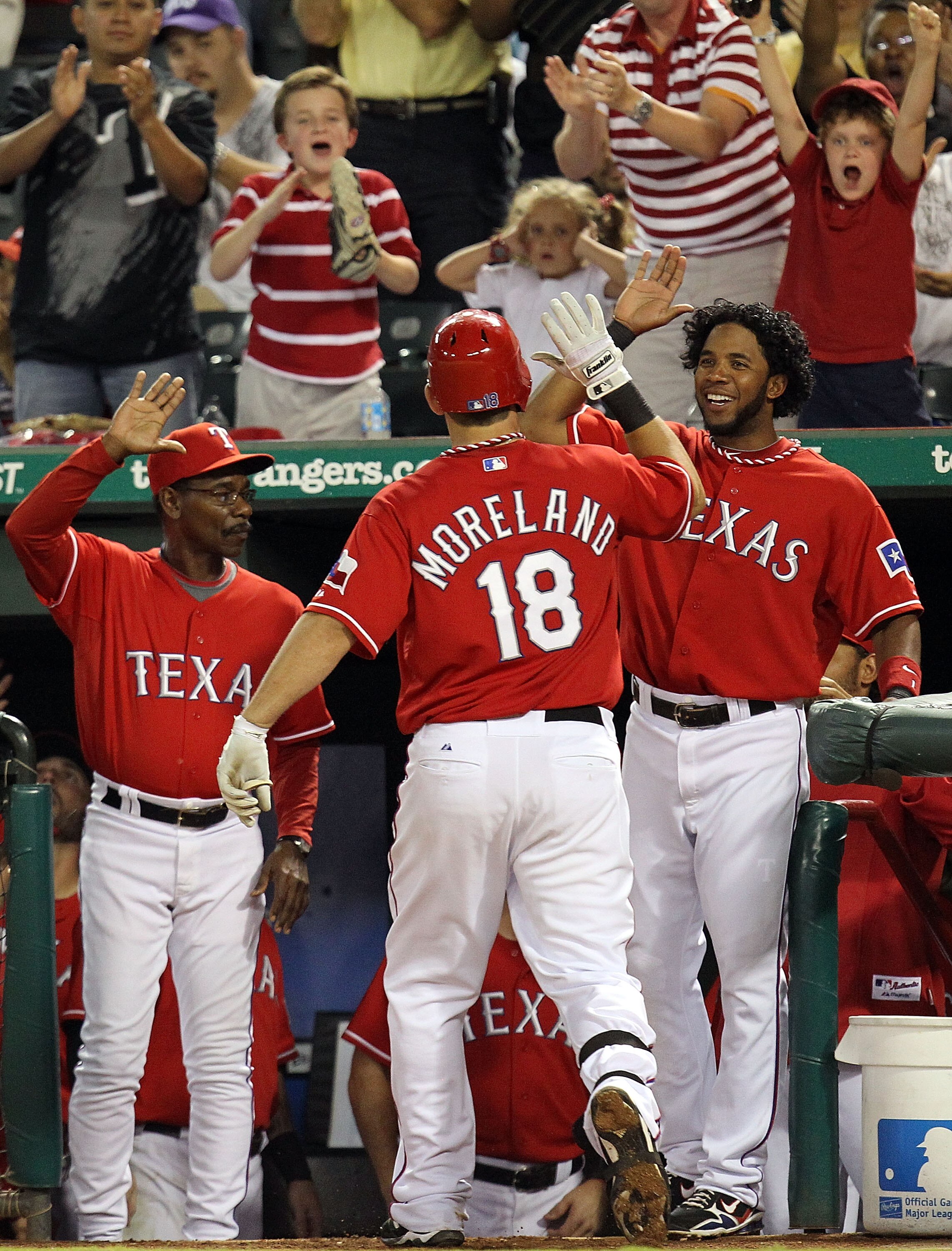 ARLINGTON, TX - OCTOBER 01:  Mitch Moreland #18 of the Texas Rangers celebrates a solo homerun with Elvis Andrus #1 and Ron Washington against the Los Angeles Angels of Anaheim at Rangers Ballpark in Arlington on October 1, 2010 in Arlington, Texas.  (Pho