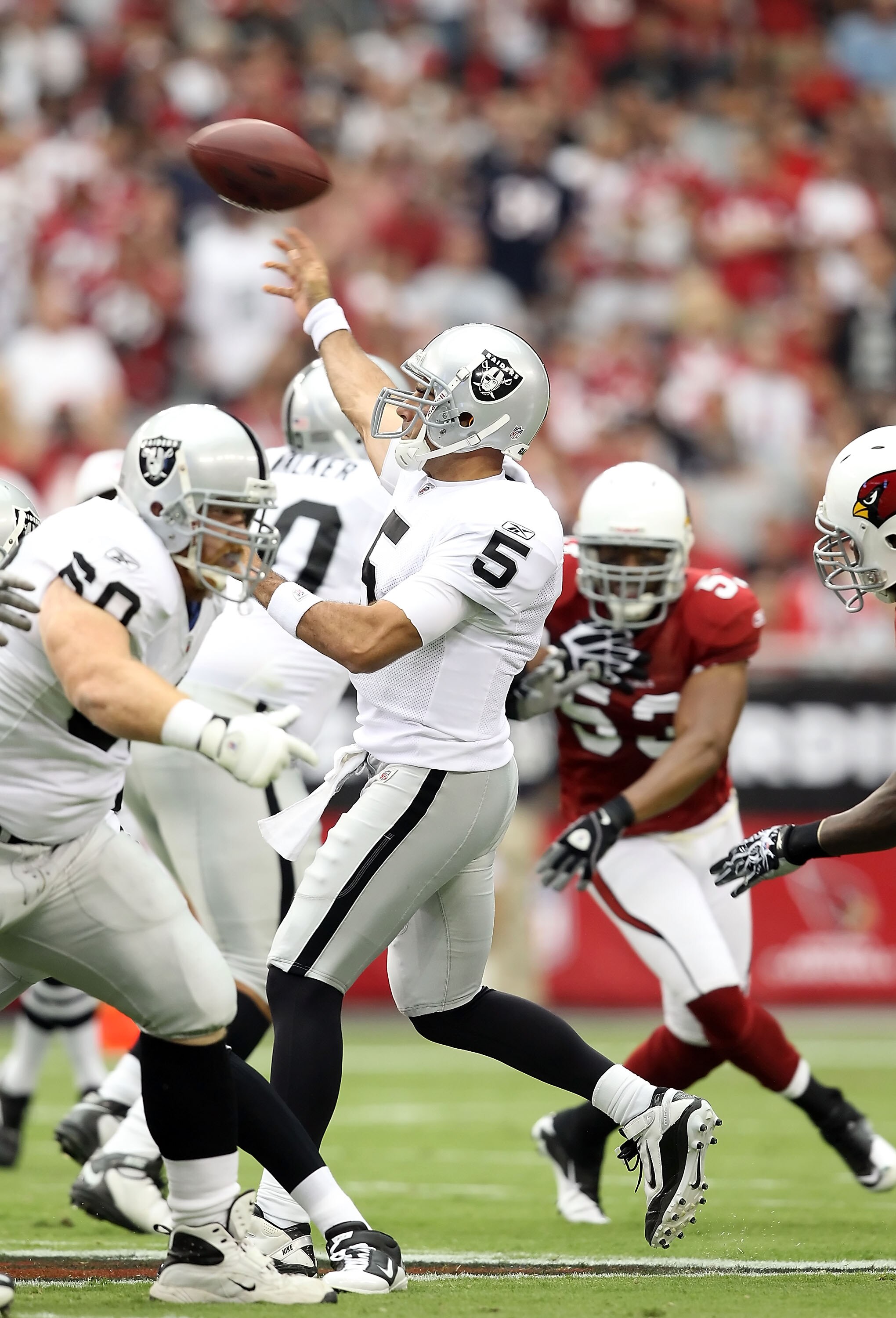 GLENDALE, AZ - SEPTEMBER 26:  Quarterback Bruce Gradkowski #5 of the Oakland Raiders throws a pass during the NFL game against the Arizona Cardinals at the University of Phoenix Stadium on September 26, 2010 in Glendale, Arizona.  The Cardinals defeated t