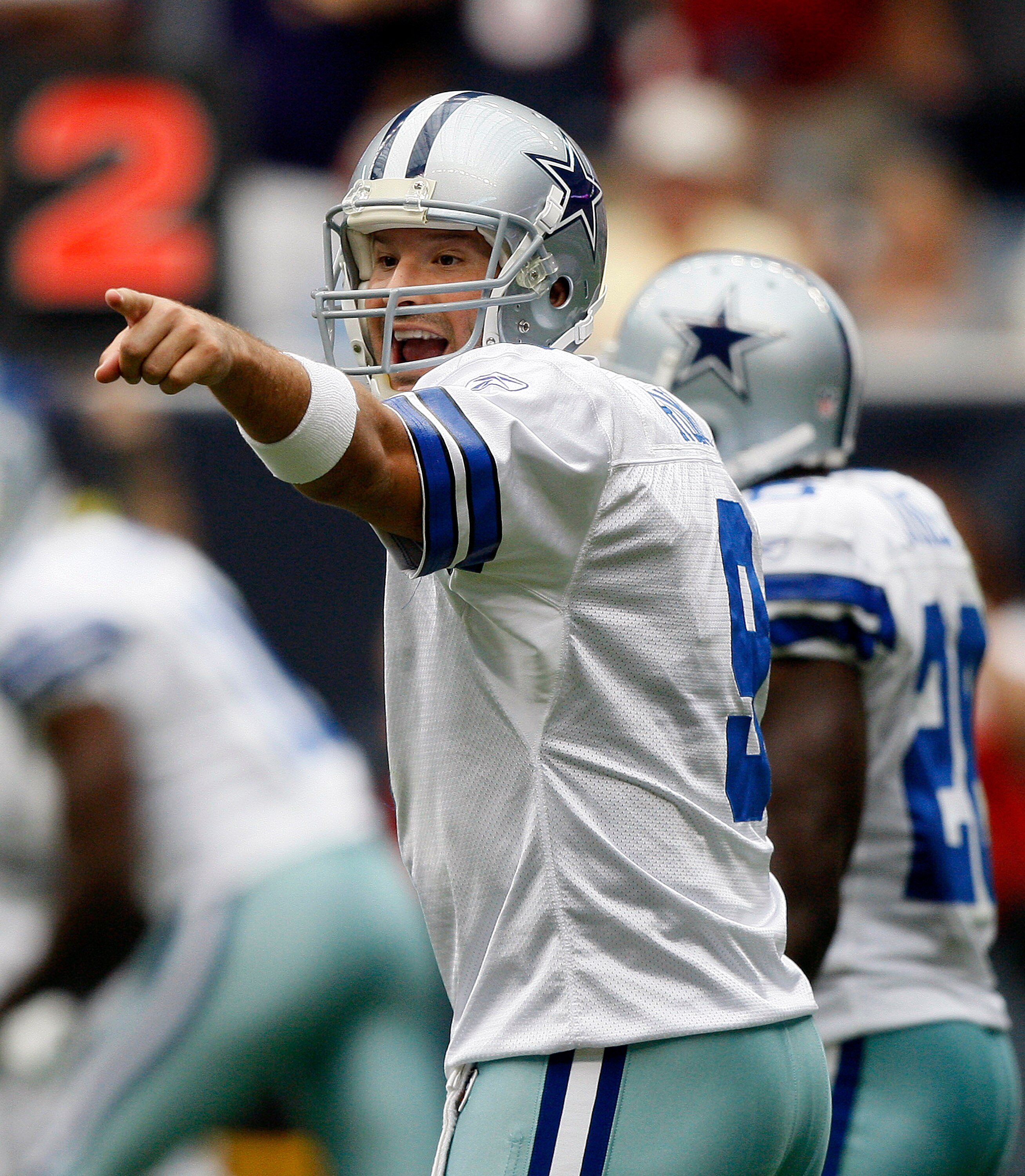 HOUSTON - SEPTEMBER 26:  Quarterback Tony Romo #9 of the Dallas Cowboys makes an adjustment at the line of scrimmage against the Houston Texans at Reliant Stadium on September 26, 2010 in Houston, Texas.  (Photo by Bob Levey/Getty Images)
