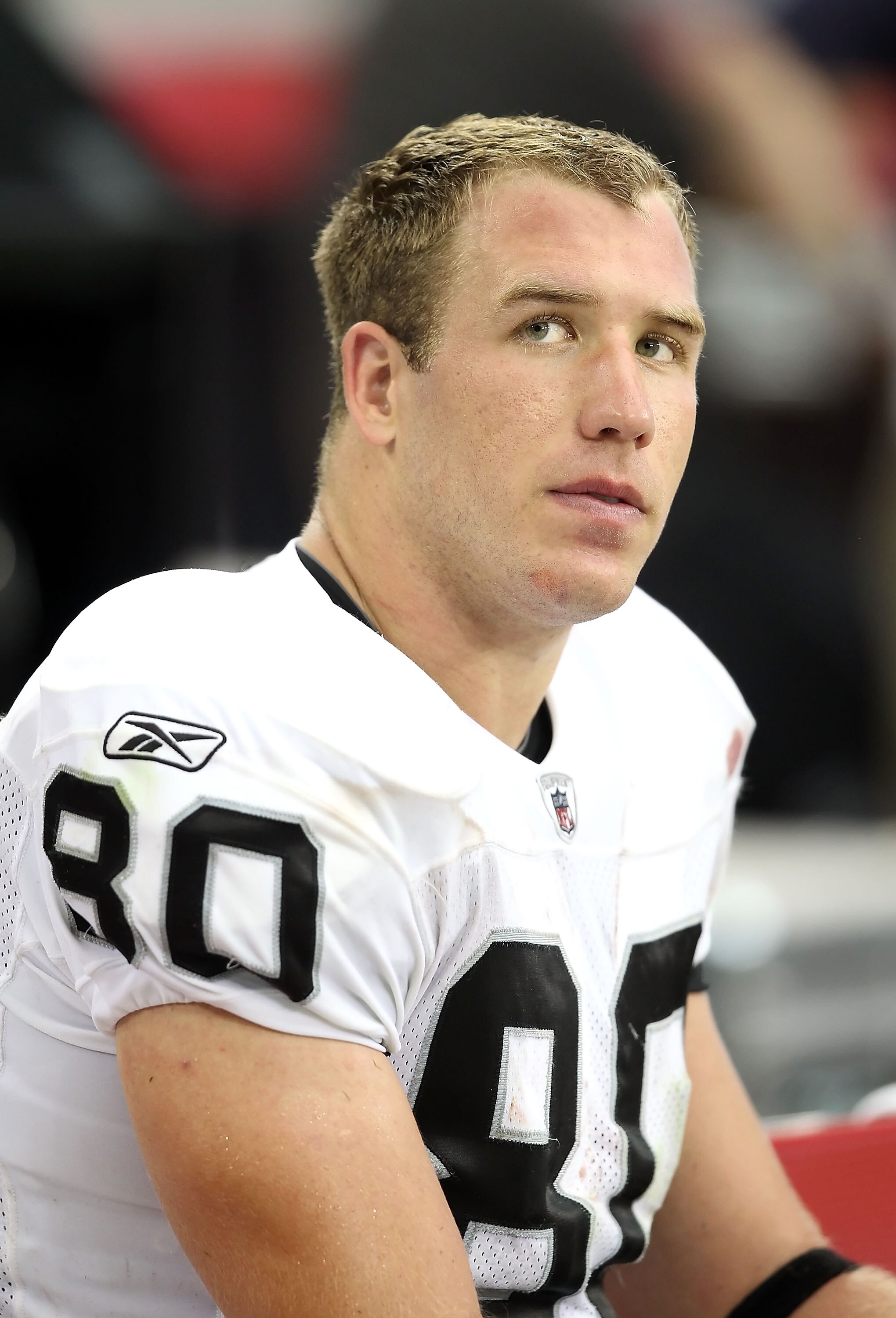 GLENDALE, AZ - SEPTEMBER 26:  Tight end Zach Miller #80 of the Oakland Raiders sits on the sidelines during the NFL game against the Arizona Cardinals at the University of Phoenix Stadium on September 26, 2010 in Glendale, Arizona.  The Cardinals defeated