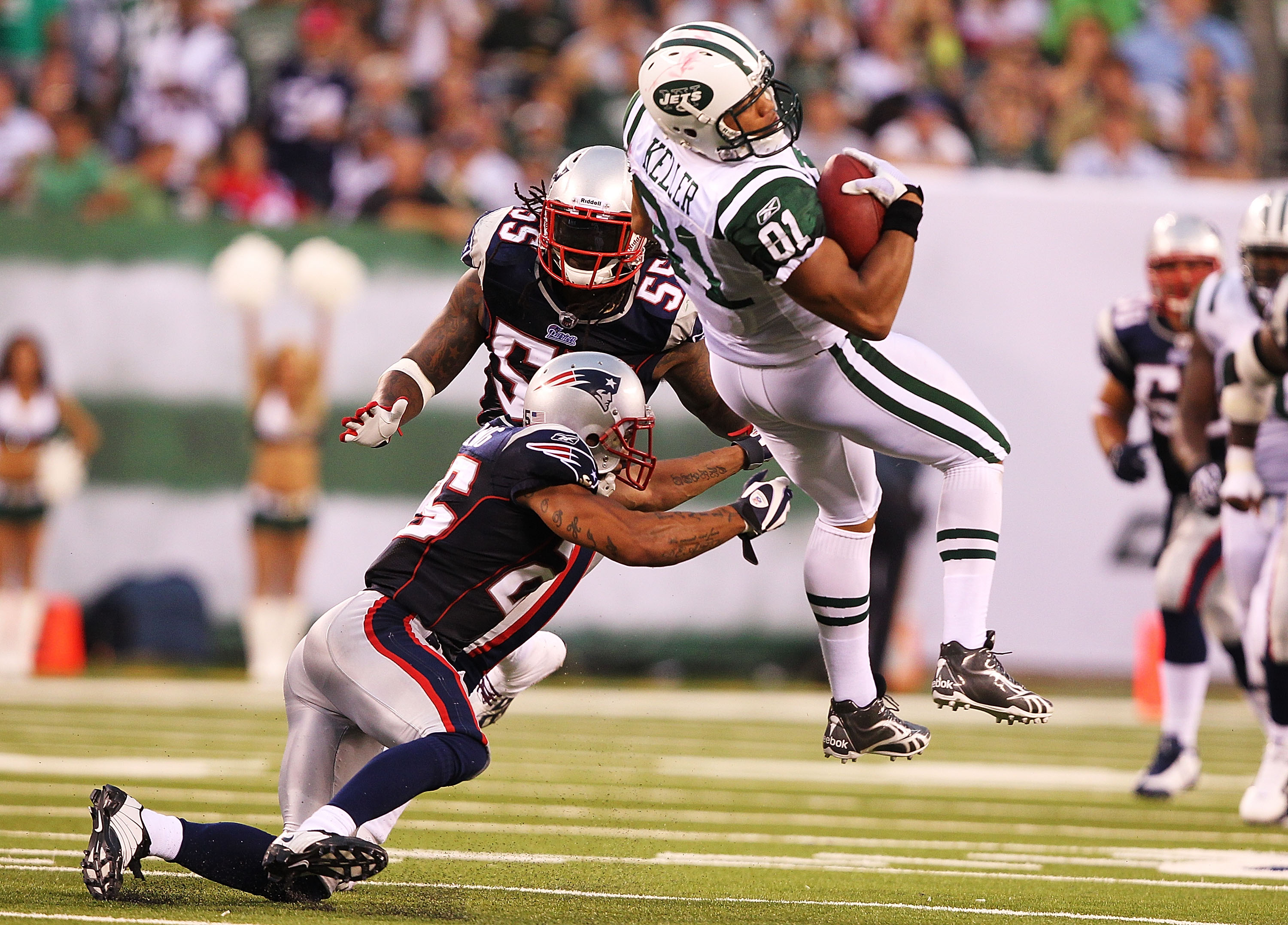 EAST RUTHERFORD, NJ - SEPTEMBER 19:  Dustin Keller #81of the New York Jets is hit by Patrick Chung #25 of the New England Patriots during their  game on September 19, 2010 at the New Meadowlands Stadium  in East Rutherford, New Jersey.  (Photo by Al Bello