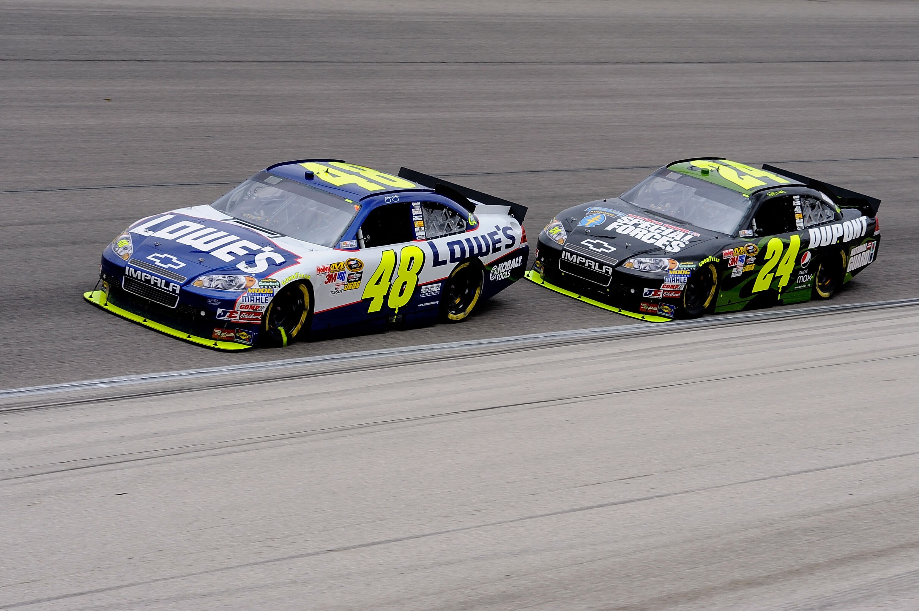 FORT WORTH, TX - APRIL 19:  Jimime Johnson, driver of the #48 Lowe's Chevrolt, leads Jeff Gordon, driver of the DuPont / National Guard Special Forces Chevrolet, during the NASCAR Sprint Cup Series Samsung Mobile 500 at Texas Motor Speedway on April 19, 2
