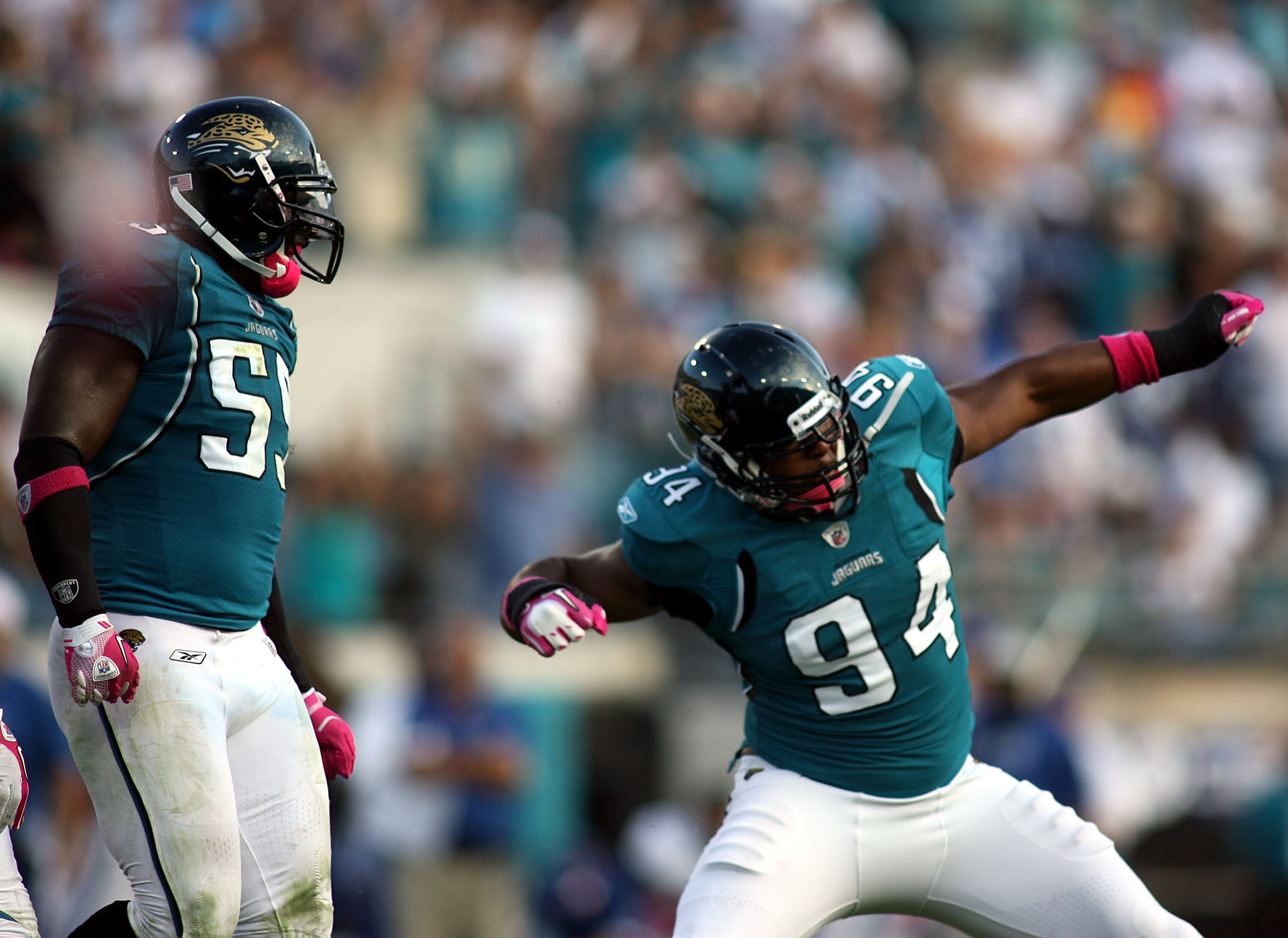 JACKSONVILLE, FL - OCTOBER 03:  Lineman Jeremy Mincey #94 of the Jacksonville Jaguars celebrates with Kirk Morreson after sacking Quarterback Peyton Manning #18 of the Indianapolis Colts at EverBank Field on October 3, 2010 in Jacksonville, Florida.  (Pho