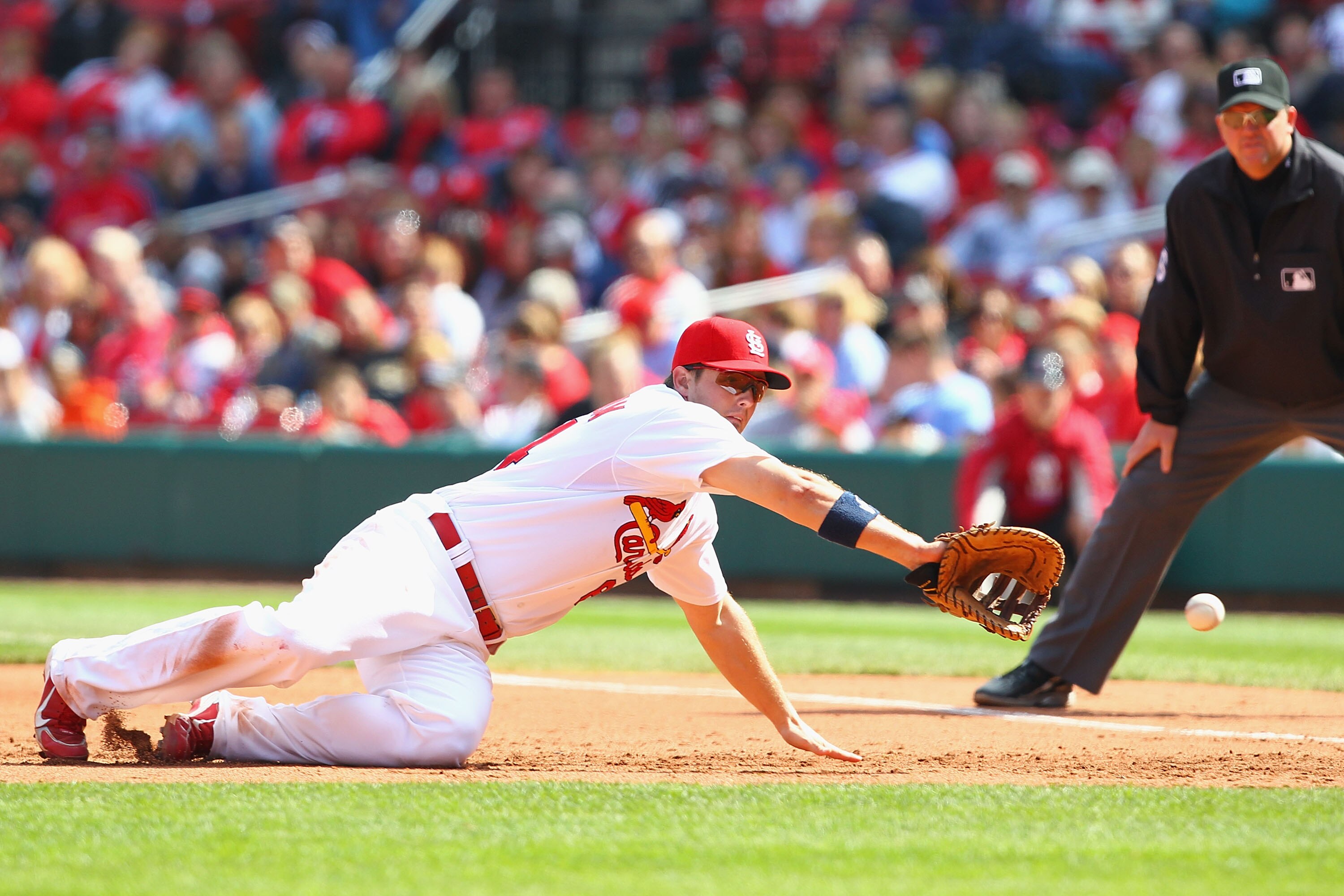 ST. LOUIS - OCTOBER 2: Mark Hamilton #64 of the St. Louis Cardinals fields a ground ball against the Colorado Rockies at Busch Stadium on October 2, 2010 in St. Louis, Missouri.  The Cardinals beat the Rockies 1-0 in 11 innings.  (Photo by Dilip Vishwanat