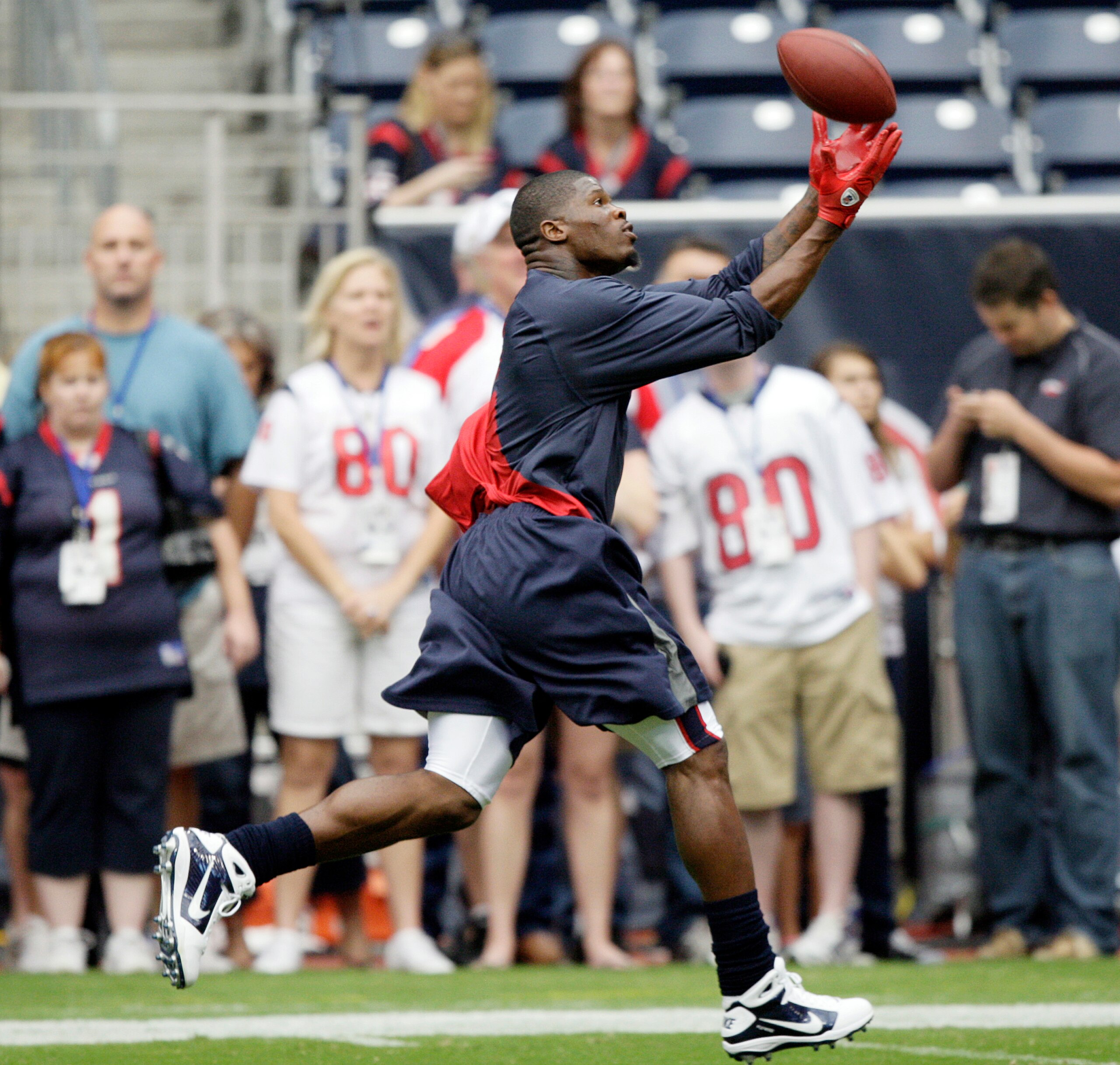 HOUSTON - SEPTEMBER 26:  Wide receiver Andre Johnson makes a reception during pre-game warm ups before playing the Dallas Cowboys at Reliant Stadium on September 26, 2010 in Houston, Texas.  (Photo by Bob Levey/Getty Images)