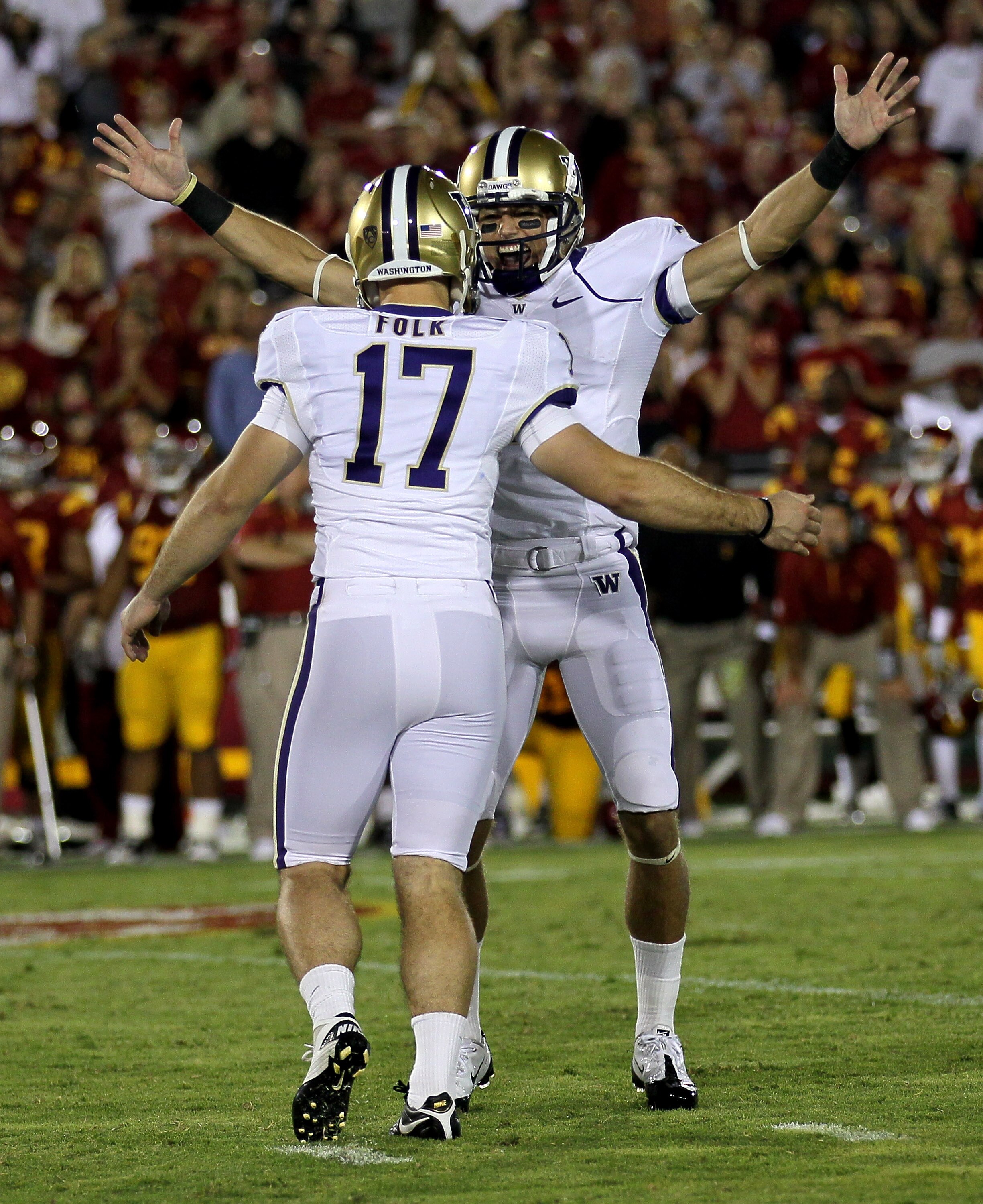 LOS ANGELES - OCTOBER 2:  Kicker Erik Folk #17 and holder Cody Bruns #7 of the Washington Huskies celebrate after Folk's game winning field goal as time ran out in the game with the USC Trojans at the Los Angeles Memorial Coliseum on October 2, 2010 in Lo