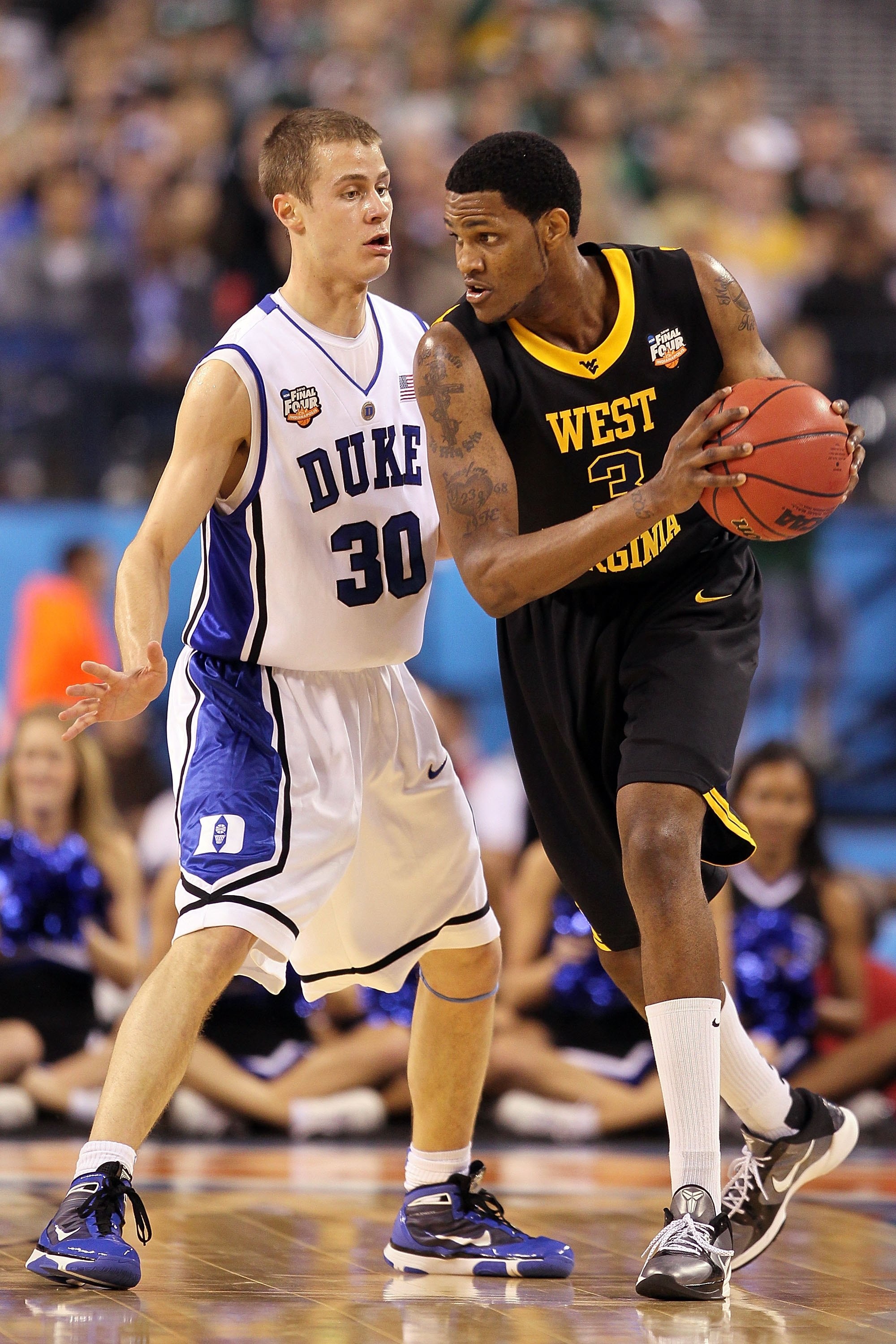 INDIANAPOLIS - APRIL 03:  Kevin Jones #5 of the West Virginia Mountaineers is guarded by Jon Scheyer #30 of the Duke Blue Devils during the National Semifinal game of the 2010 NCAA Division I Men's Basketball Championship at Lucas Oil Stadium on April 3,