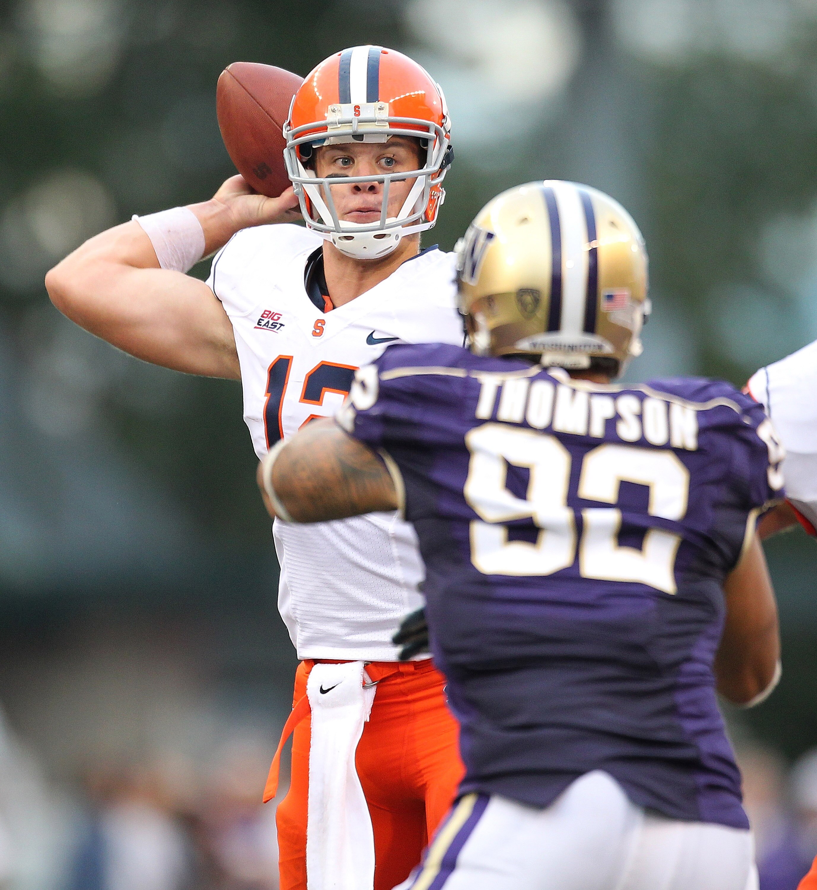 SEATTLE - SEPTEMBER 11:  Quarterback Ryan Nassib #12 of the Syracuse Orange passes against Everrette Thompson #92 of the Washington Huskies on September 11, 2010 at Husky Stadium in Seattle, Washington. The Huskies defeated the Orange 41-20. (Photo by Ott