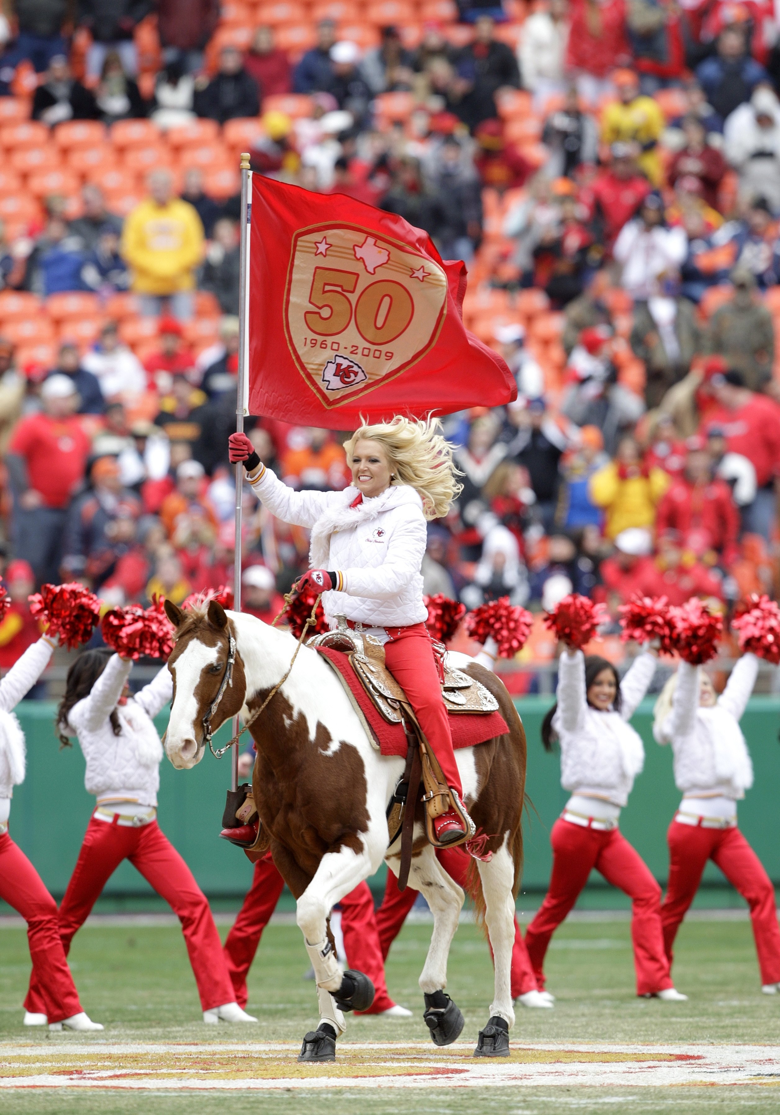 KANSAS CITY, MO - DECEMBER 6:  A cheerleader of the Kansas City Chiefs rides a horse onto the field carrying a Kansas City Cheifs flag prior to the NFL game against the Denver Broncos on December 6, 2009 at Arrowhead Stadium in Kansas City, Missouri. The 