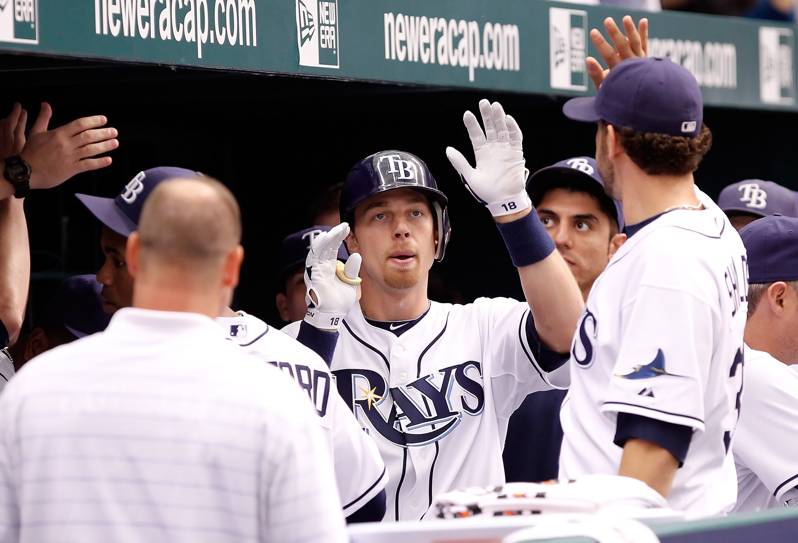 ST. PETERSBURG, FL - OCTOBER 06:  Outfielder Ben Zobrist #18 of the Tampa Bay Rays is congratulated after his home run against the Texas Rangers during Game 1 of the ALDS at Tropicana Field on October 6, 2010 in St. Petersburg, Florida.  (Photo by J. Meri