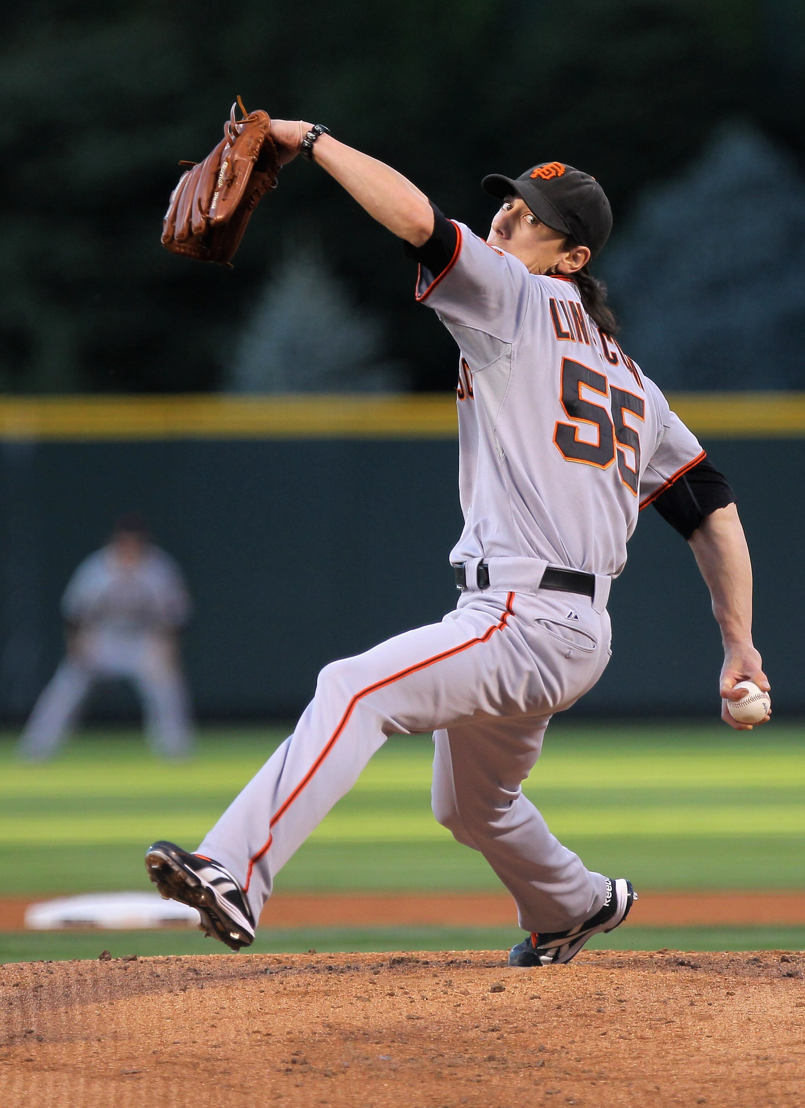 DENVER - SEPTEMBER 24:  Starting pitcher Tim Lincecum #55 of the San Francisco Giants delivers against the Colorado Rockies at Coors Field on September 24, 2010 in Denver, Colorado. Lincecum earned the win as the Giants defeated the Rockies 2-1.  (Photo b