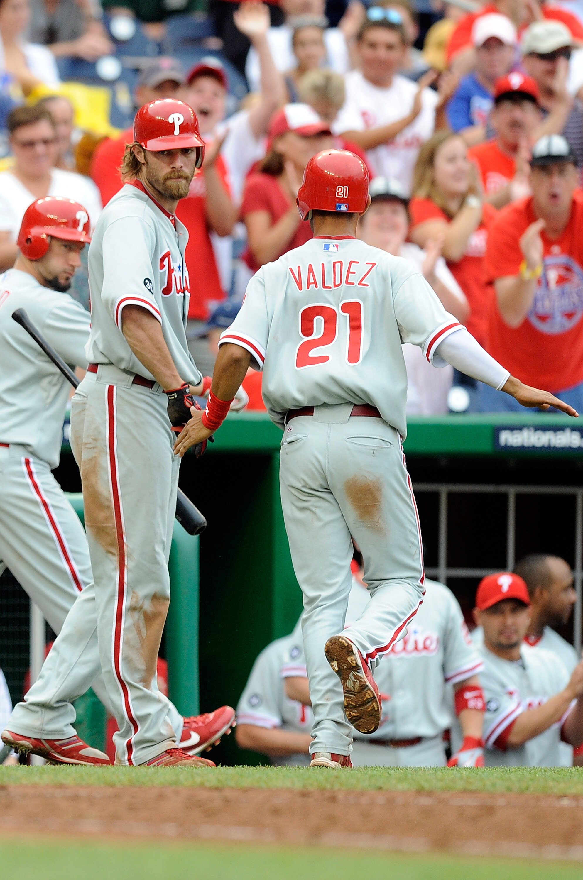 WASHINGTON - AUGUST 01:  Wilson Valdez #21 of the Philadelphia Phillies is congratulated by Jayson Werth #28 after scoring in the eleventh inning against the Washington Nationals at Nationals Park on August 1, 2010 in Washington, DC. The Phillies won the 