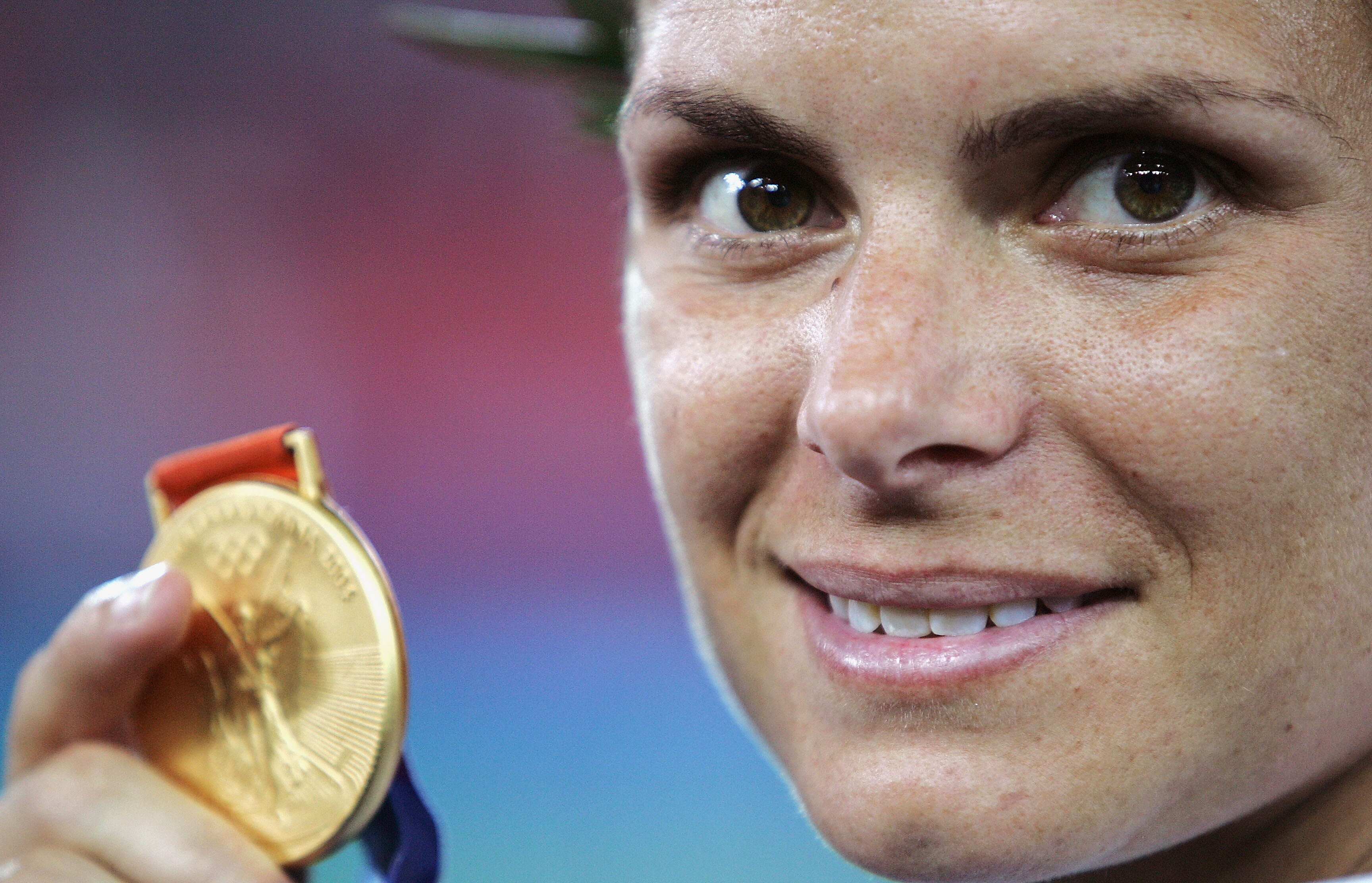 ATHENS - AUGUST 26:  Mia Hamm of the USA holds her gold medal after the women's football gold medal match on August 26, 2004 during the Athens 2004 Summer Olympic Games at Karaiskaki Stadium in Athens, Greece. (Photo by Shaun Botterill/Getty Images)