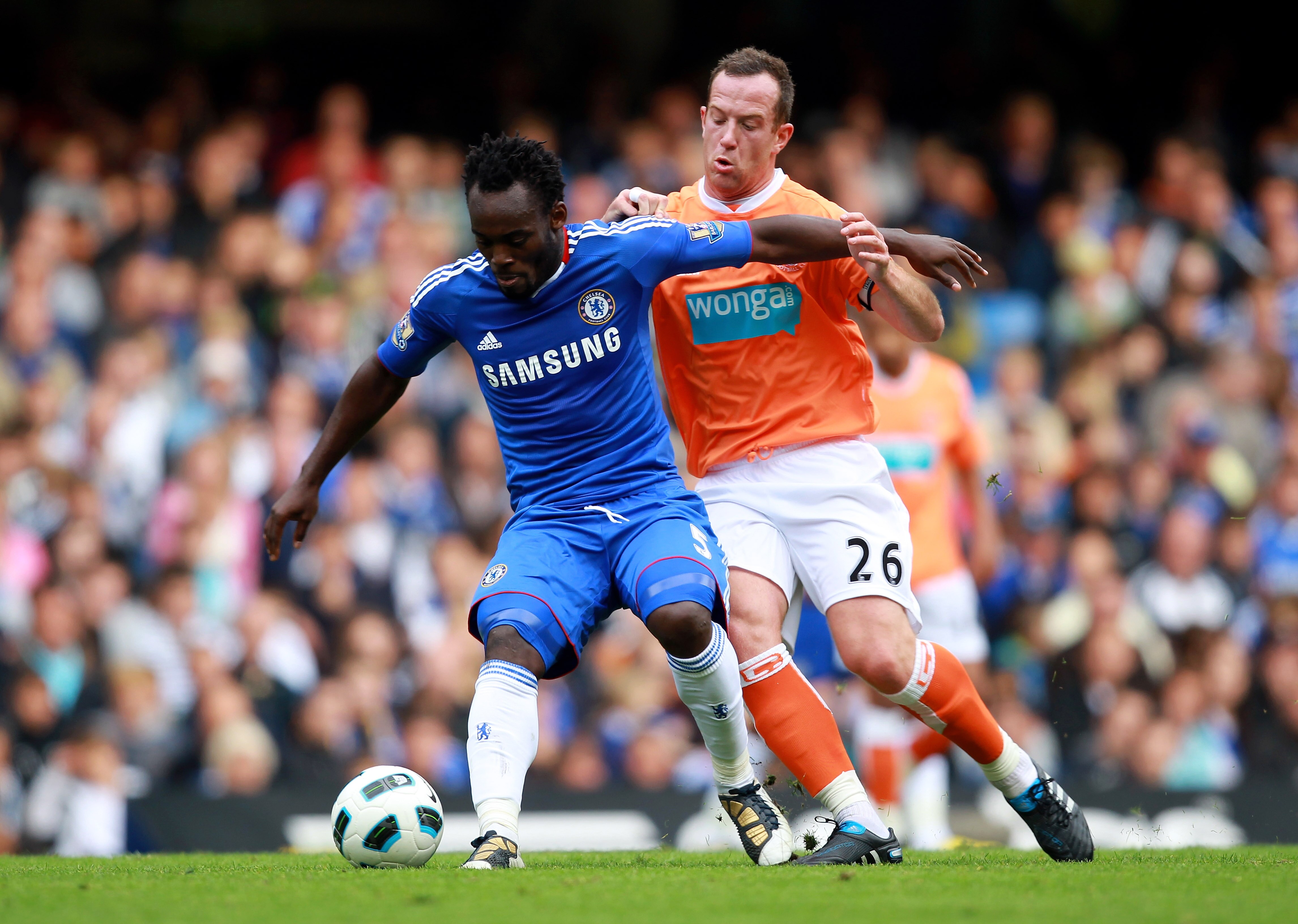 LONDON, ENGLAND - SEPTEMBER 19:  Michael Essien of Chelsea is challenged by Charlie Adam of Blackpool during the Barclays Premier League match between Chelsea and Blackpool at Stamford Bridge on September 19, 2010 in London, England.  (Photo by Warren Lit