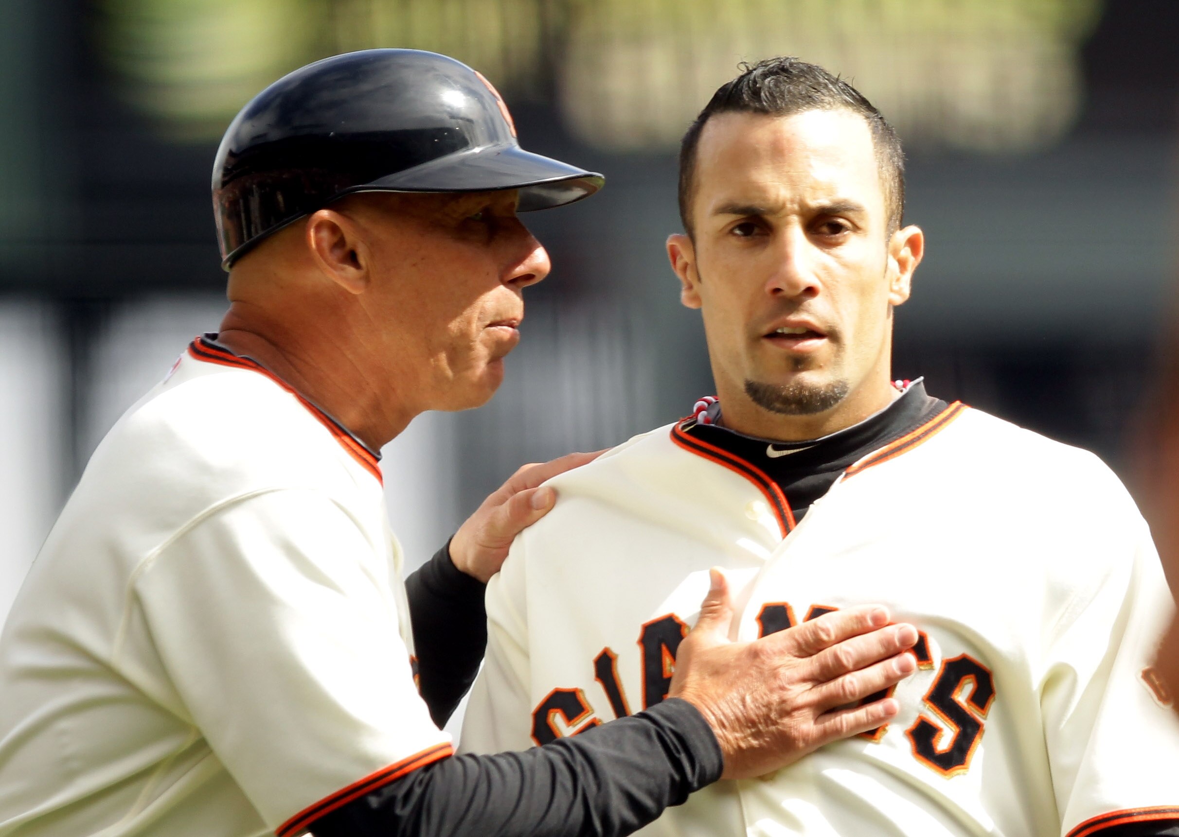 SAN FRANCISCO - OCTOBER 03:  Third base coach Tim Flannery speaks to Andres Torres #56 of the San Francisco Giants after a hit that would have been a double was ruled a foul ball in the first inning of their game against the San Diego Padres at AT&T Park 