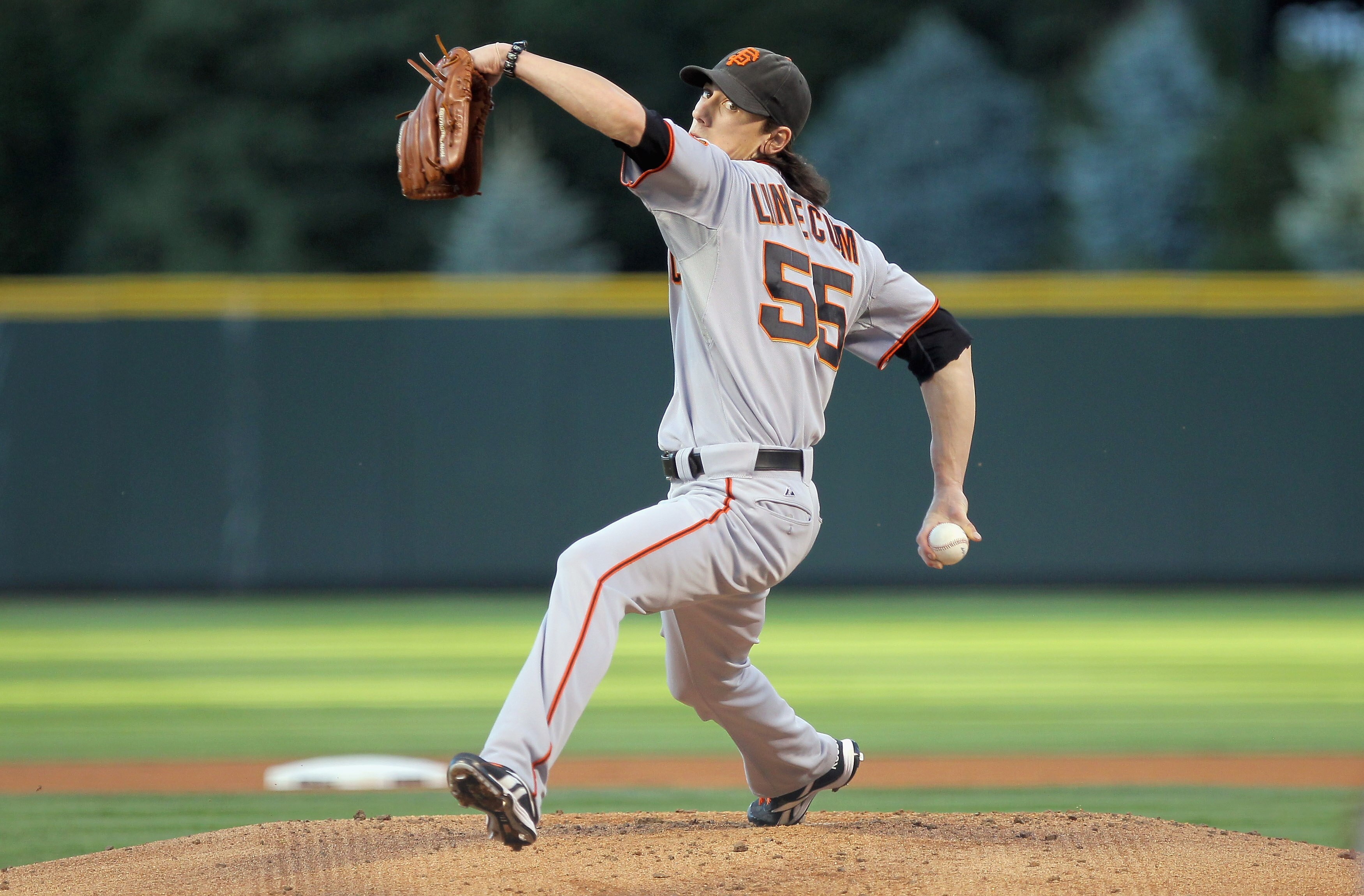 DENVER - SEPTEMBER 24:  Starting pitcher Tim Lincecum #55 of the San Francisco Giants delivers against the Colorado Rockies at Coors Field on September 24, 2010 in Denver, Colorado. Lincecum earned the win as the Giants defeated the Rockies 2-1.  (Photo b