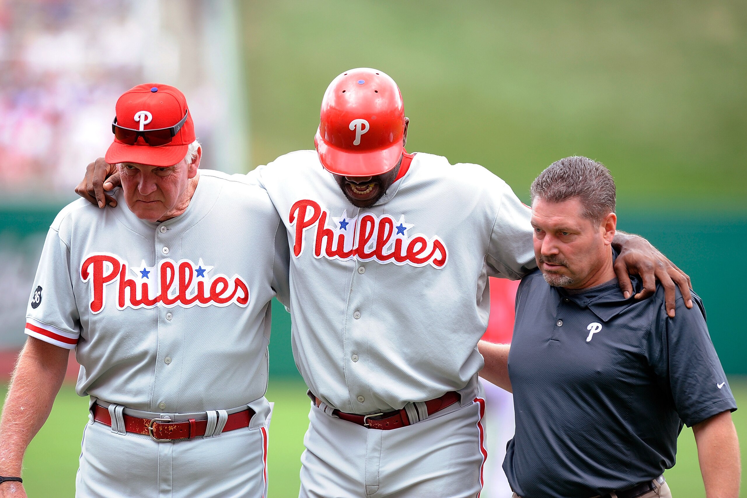 WASHINGTON - AUGUST 01:  Ryan Howard #6 of the Philadelphia Phillies is helped off the field by manager Charlie Manuel and a Philadelphia trainer after injuring his ankle during the first inning against the Washington Nationals at Nationals Park on August