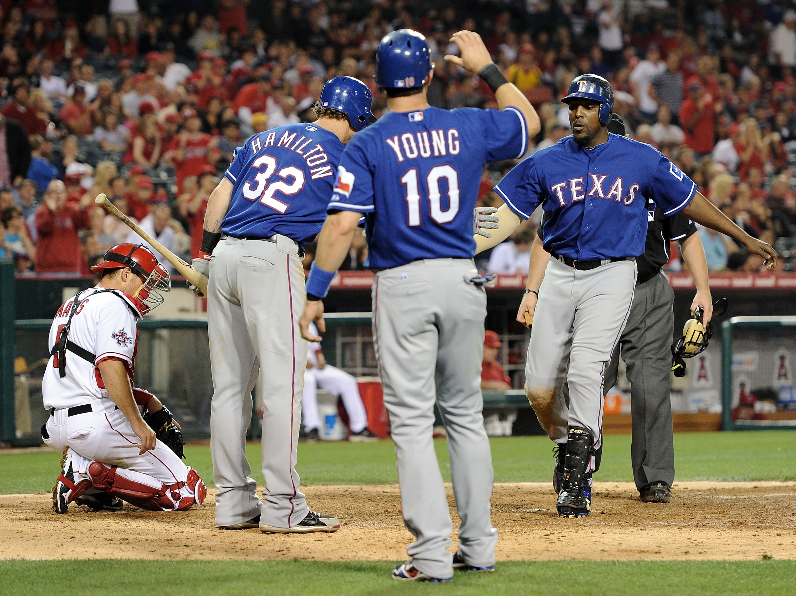 ANAHEIM, CA - JUNE 29:  Vladimir Guerrero #27 of the Texas Rangers celebrates his two run homerun over the Los Angeles Angels to trail 6-5 with Josh Hamilton #32 and Michael Young #10 during the seventh inning at Angel Stadium on June 29, 2010 in Anaheim,
