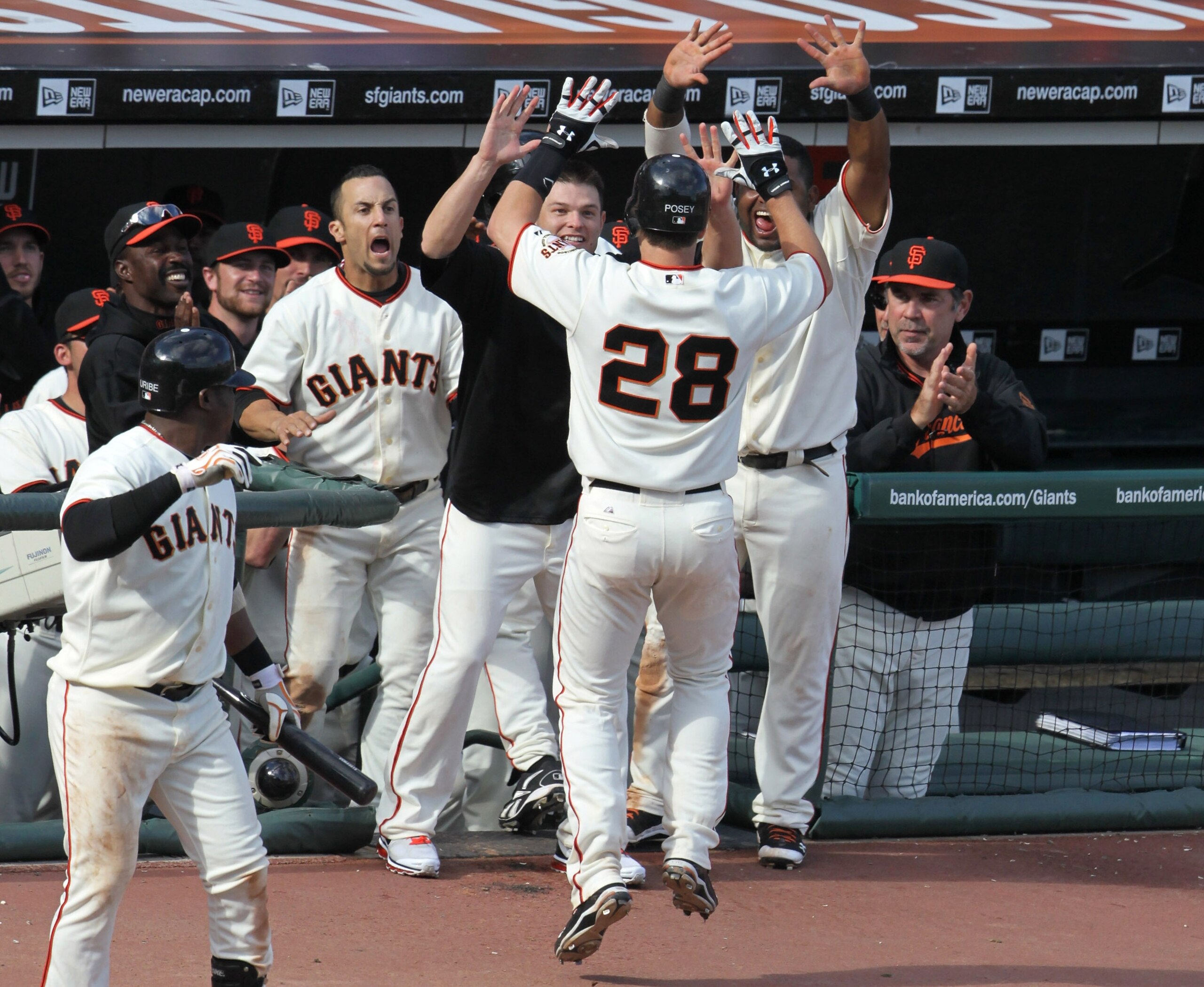 SAN FRANCISCO - OCTOBER 03:  Buster Posey #28 of the San Francisco Giants is congratulated by teammates after hitting a solo home run during the eighth inning against the San Diego Padres at AT&T Park on October 3, 2010 in San Francisco, California.  The