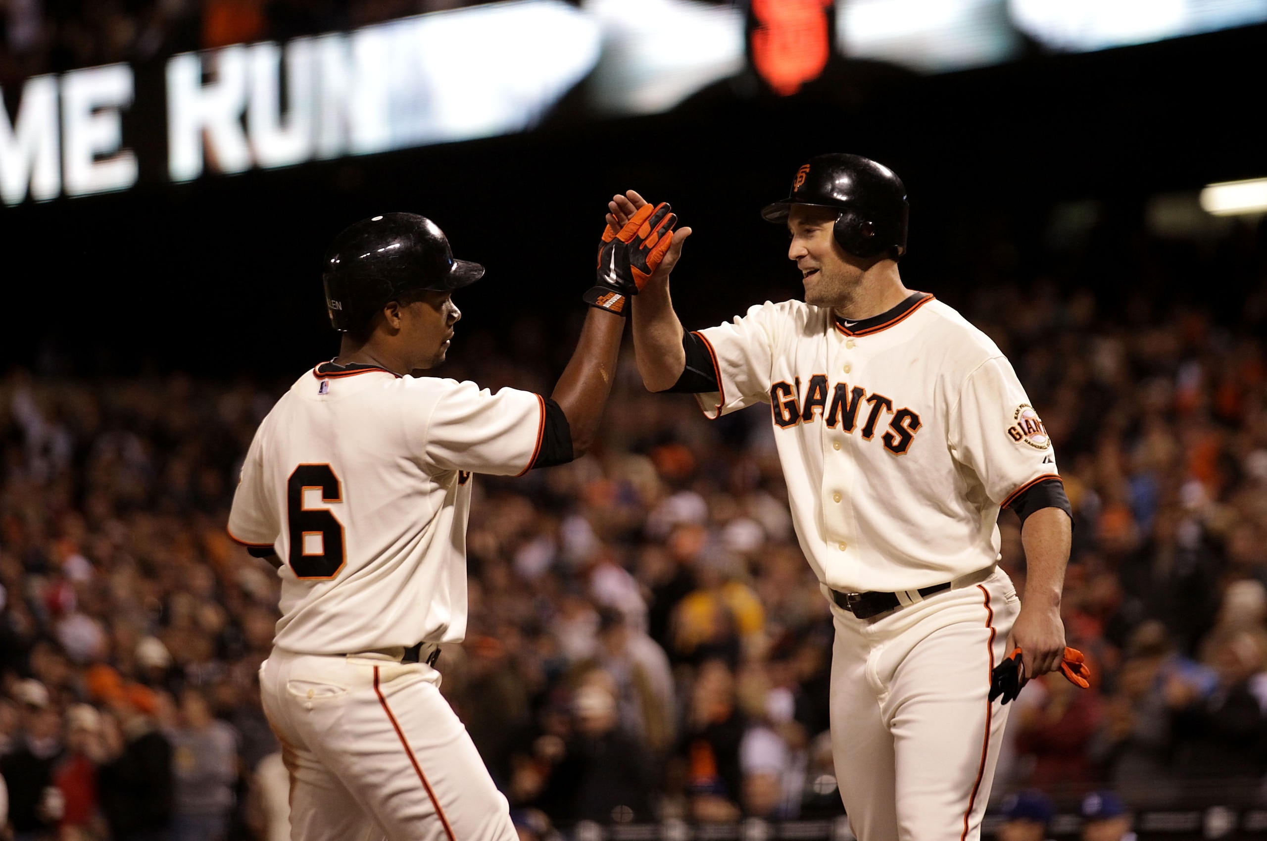 SAN FRANCISCO - SEPTEMBER 16: Jose Gullien #6 of the San Francisco Giants celebrates with Pat Burrell #9 after hitting a two run home in the fifth inning gainst the Los Angeles Dodgers during a Major League Baseball game at AT&T Park on September 16, 2010