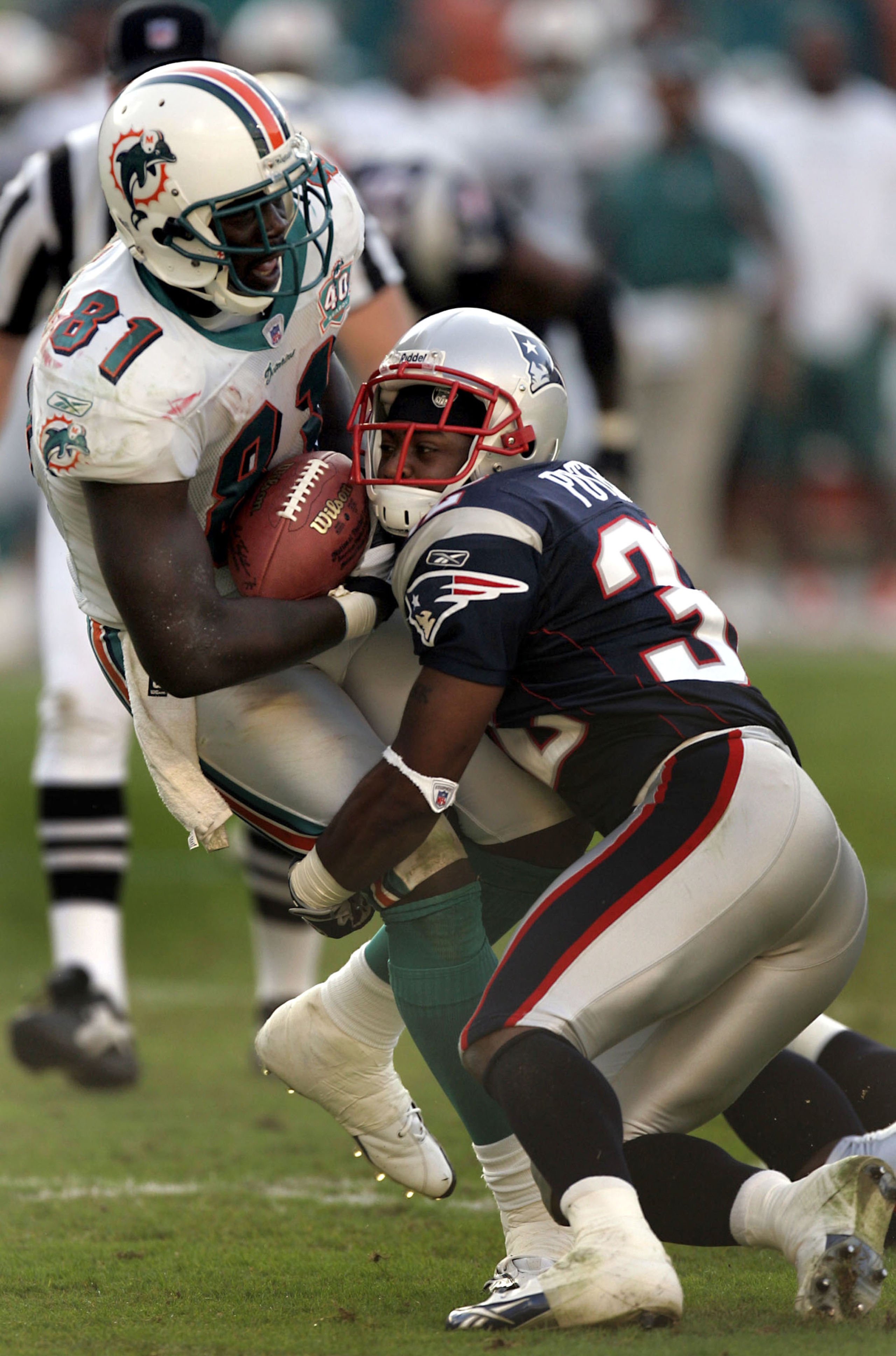MIAMI - NOVEMBER 13: Tight end Randy McMichael #81 of the Miami Dolphins is stopped by cornerback Hank Poteat #32 of the New England Patriots in the fourth quarter on November 13, 2005 at Miami Dolphins Stadium in Miami, Florida. The Patriots defeated th MIAMI - NOVEMBER 13: Tight end Randy McMichael #81 of the Miami Dolphins is stopped by cornerback Hank Poteat #32 of the New England Patriots in the fourth quarter on November 13, 2005 at Miami Dolphins Stadium in Miami, Florida. The Patriots defeated th