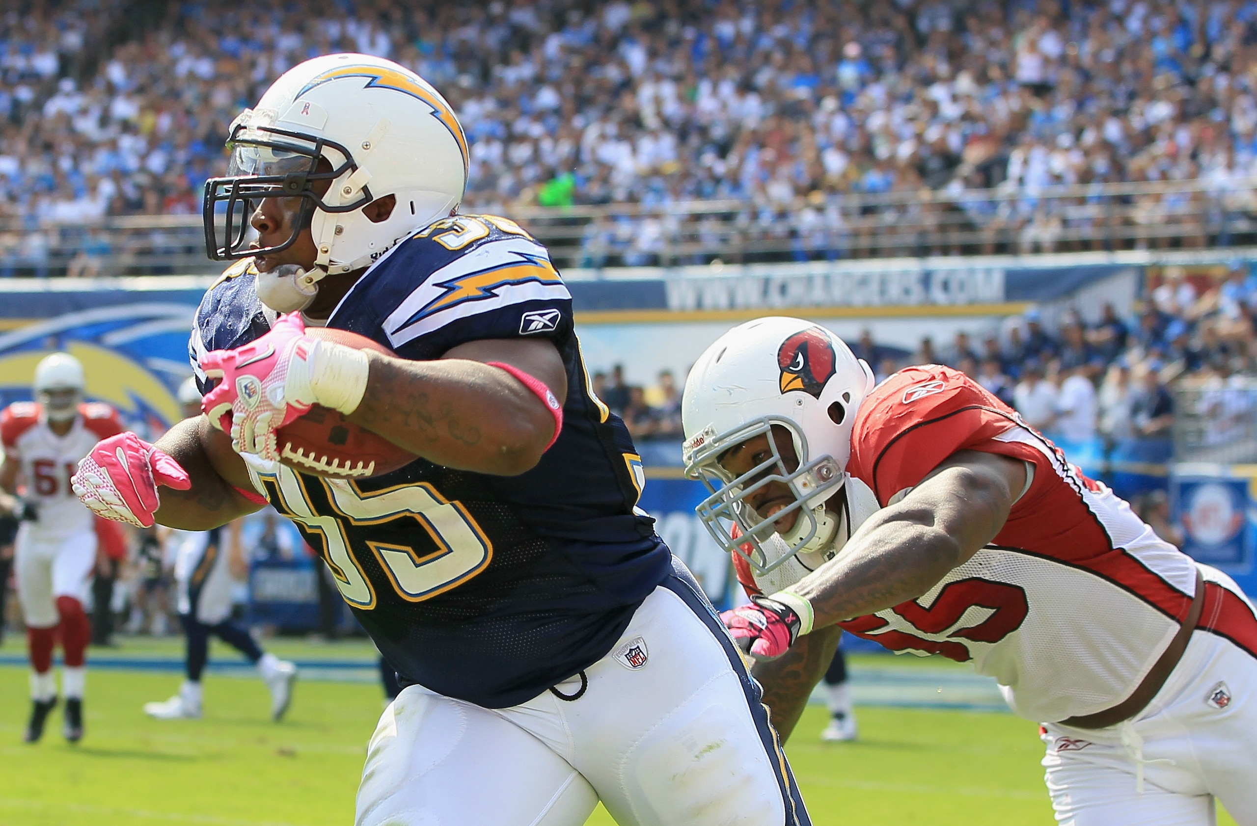 SAN DIEGO - OCTOBER 03:  Running back Mike Tolbert #35 of the San Diego Chargers carries the ball while being pursued by Joey Porter #55 of the Arizona Cardinals in the third quarter at Qualcomm Stadium on October 3, 2010 in San Diego, California. The Cha