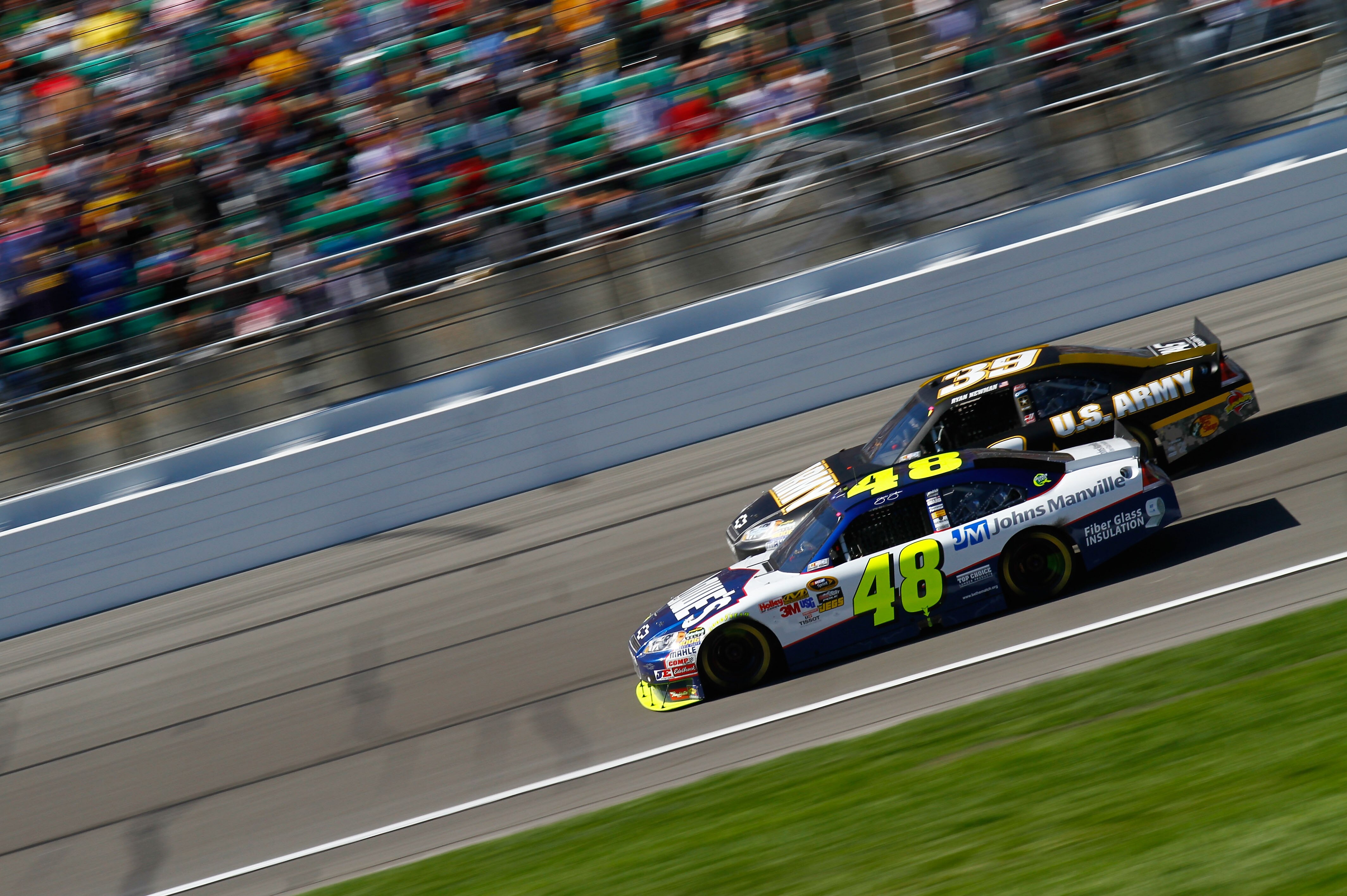 KANSAS CITY, KS - OCTOBER 03:  Jimmie Johnson, driver of the #48 Lowe's Chevrolet, races Ryan Newman, driver of the #39 U.S. Army Chevrolet, during the NASCAR Sprint Cup Series Price Chopper 400 on October 3, 2010 in Kansas City, Kansas.  (Photo by Jason