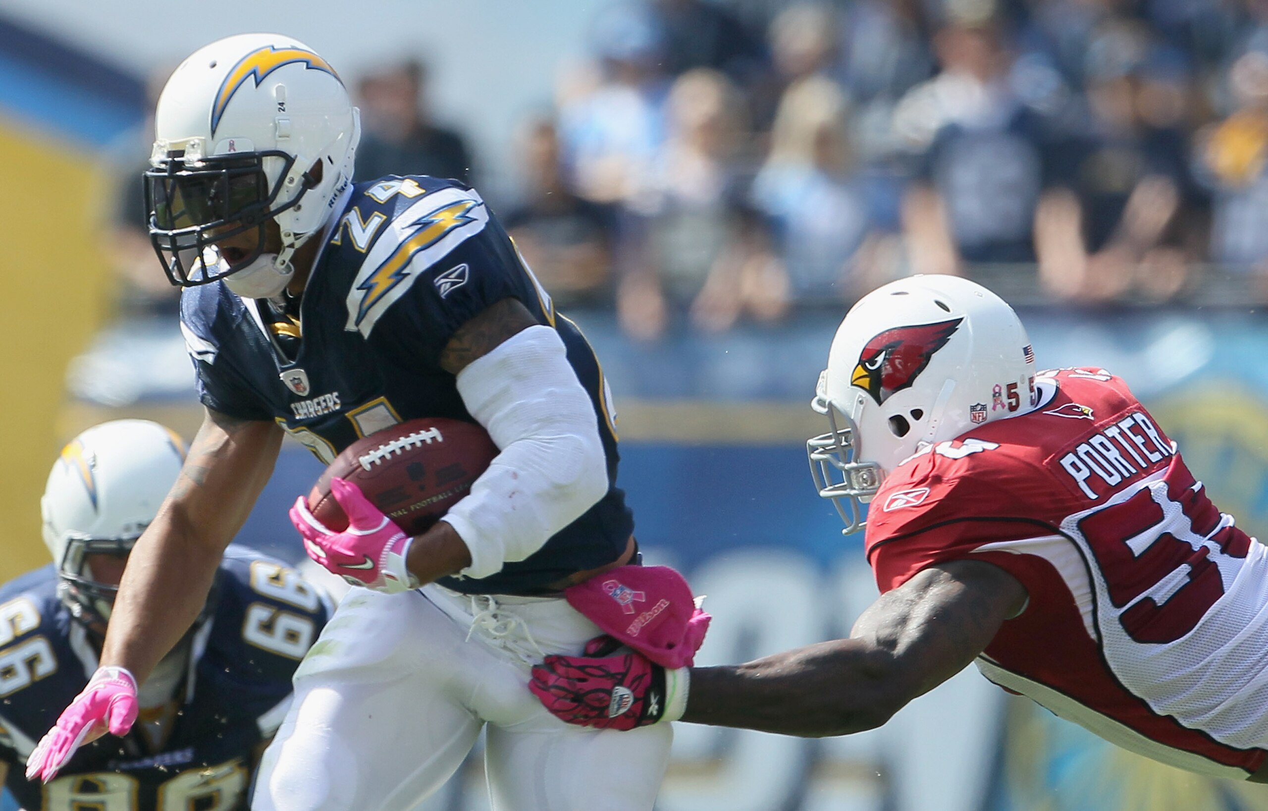 SAN DIEGO - OCTOBER 03:  Running back Ryan Mathews #24 of the San Diego Chargers carries the ball while being pursued by Joey Porter #55 of the Arizona Cardinals in the first quarter at Qualcomm Stadium on October 3, 2010 in San Diego, California. The Cha