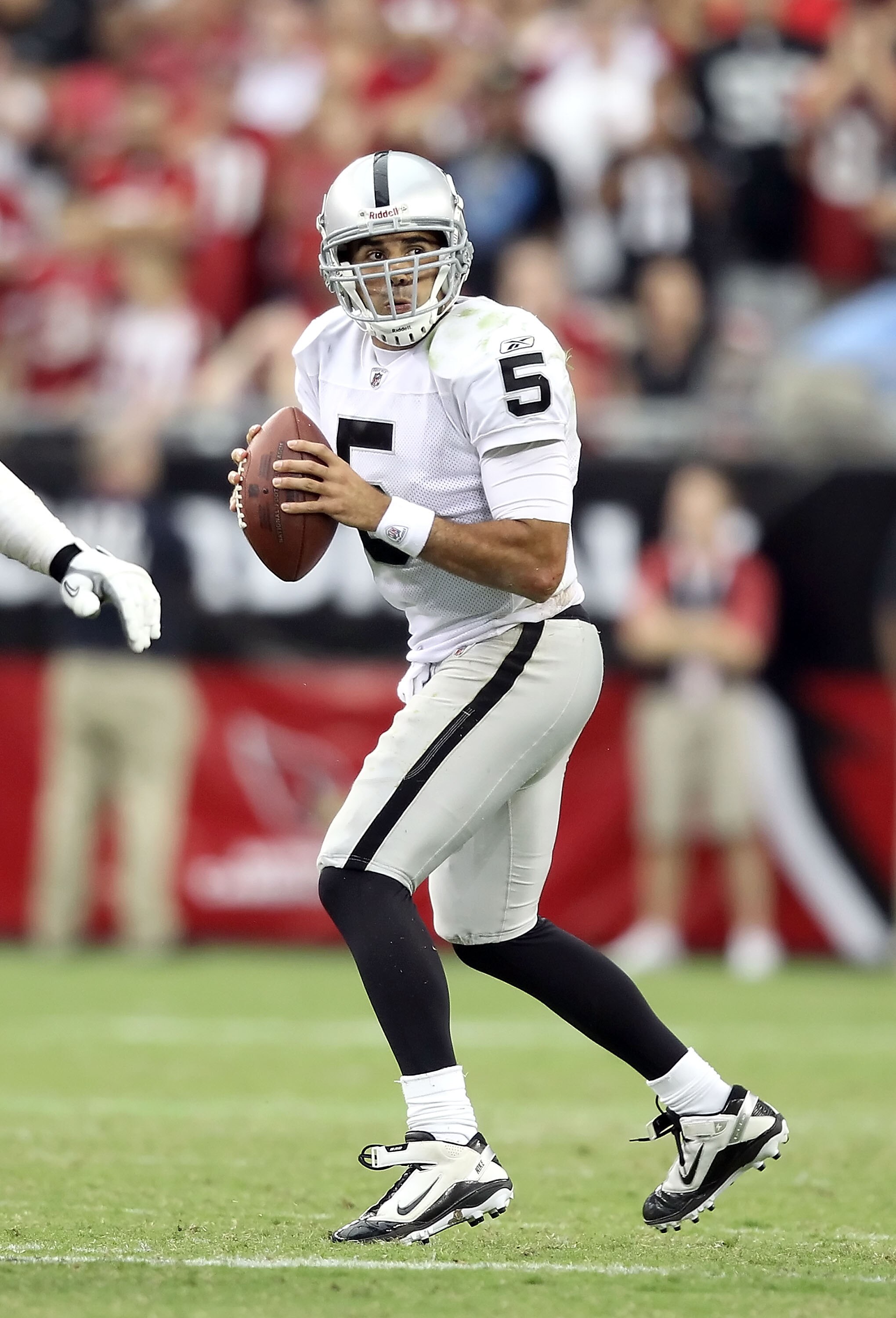 GLENDALE, AZ - SEPTEMBER 26:  Quarterback Bruce Gradkowski #5 of the Oakland Raiders drops back to pass during the NFL game against the Arizona Cardinals at the University of Phoenix Stadium on September 26, 2010 in Glendale, Arizona.  The Cardinals defea