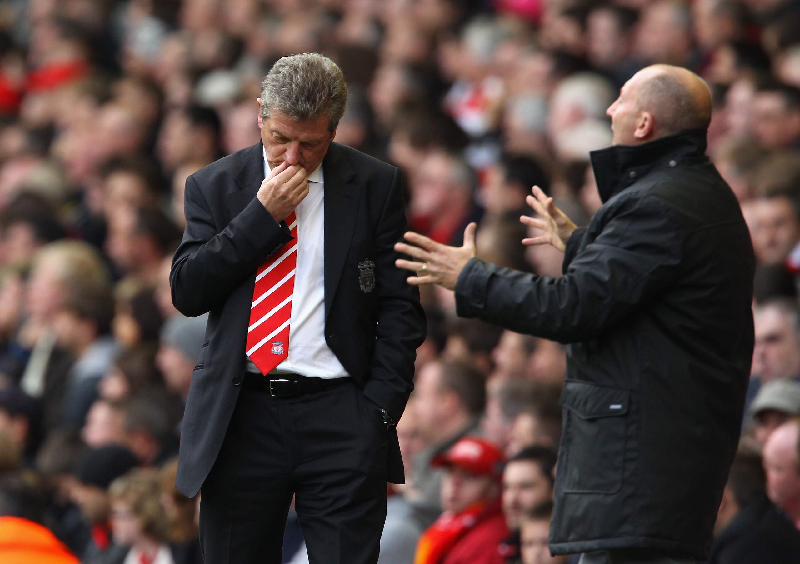 LIVERPOOL, ENGLAND - OCTOBER 03:  Roy Hodgson the manager of Liverpool looks dejected as Ian Holloway the manager of Blackpool gives instructions to his players during the Barclays Premier League match between Liverpool and Blackpool at Anfield on October
