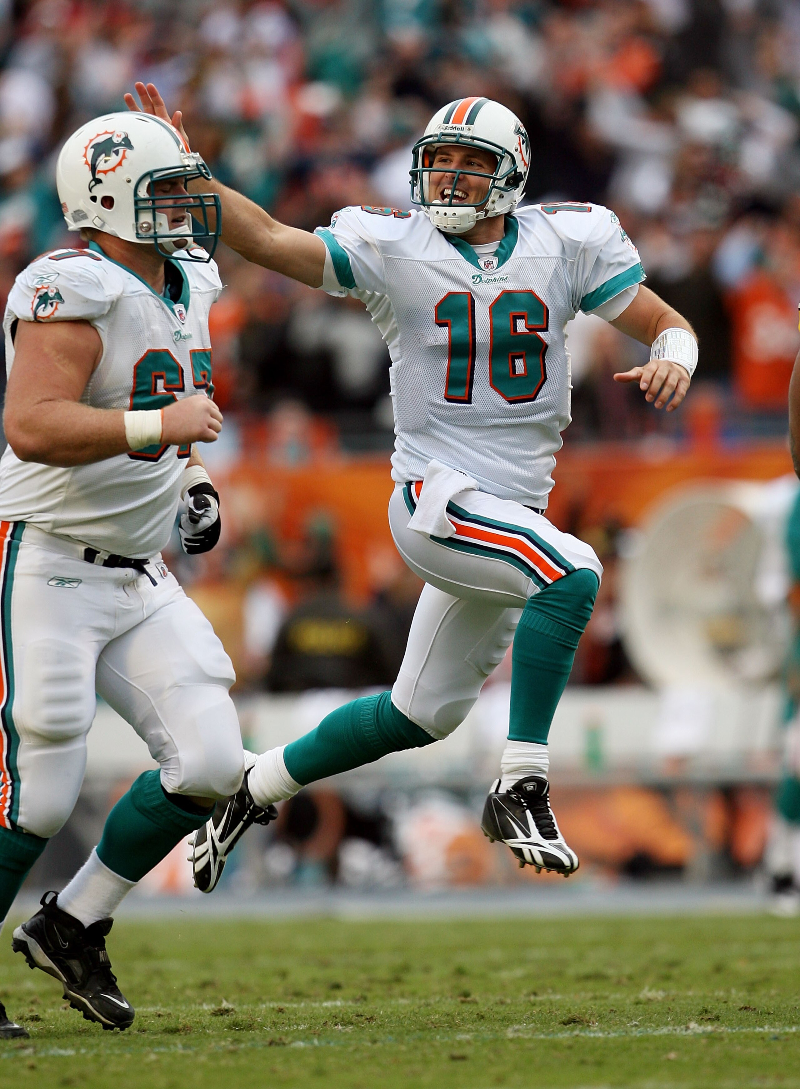 MIAMI - JANUARY 03:  Quarterback Tyler Thigpen #16 of the Miami Dolphins slaps the head of offensive lineman Joe Berger #67 to celebrate his touchdown pass to Davone Bess #15 against the Pittsburgh Steelers at Land Shark Stadium on January 3, 2010 in Miam
