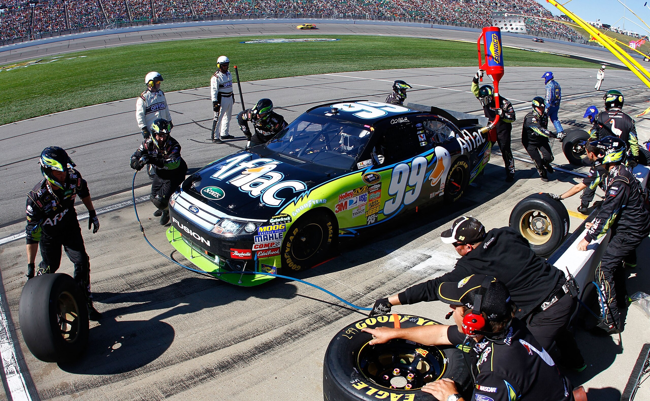 KANSAS CITY, KS - OCTOBER 03:  Carl Edwards, driver of the #99 Aflac Ford, makes a pit stop during the NASCAR Sprint Cup Series Price Chopper 400 on October 3, 2010 in Kansas City, Kansas.  (Photo by Jason Smith/Getty Images for NASCAR)