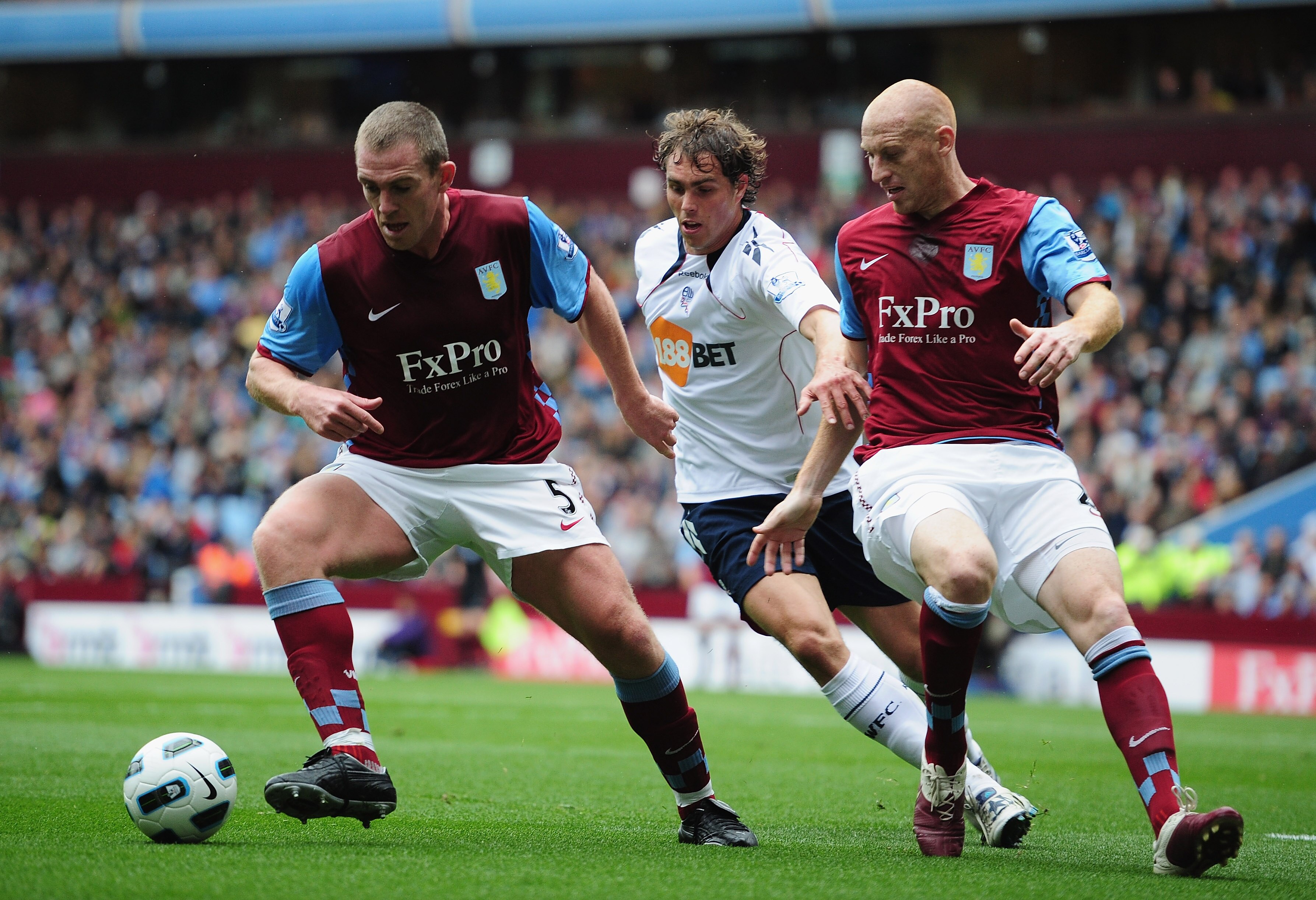 BIRMINGHAM, ENGLAND - SEPTEMBER 18:  Richard Dunne and James Collins of Aston Villa squeeze out Johan Elmander of Bolton during the Barclays Premier League match between Aston villa and Bolton Wanderers at Villa Park on September 18, 2010 in Birmingham, E