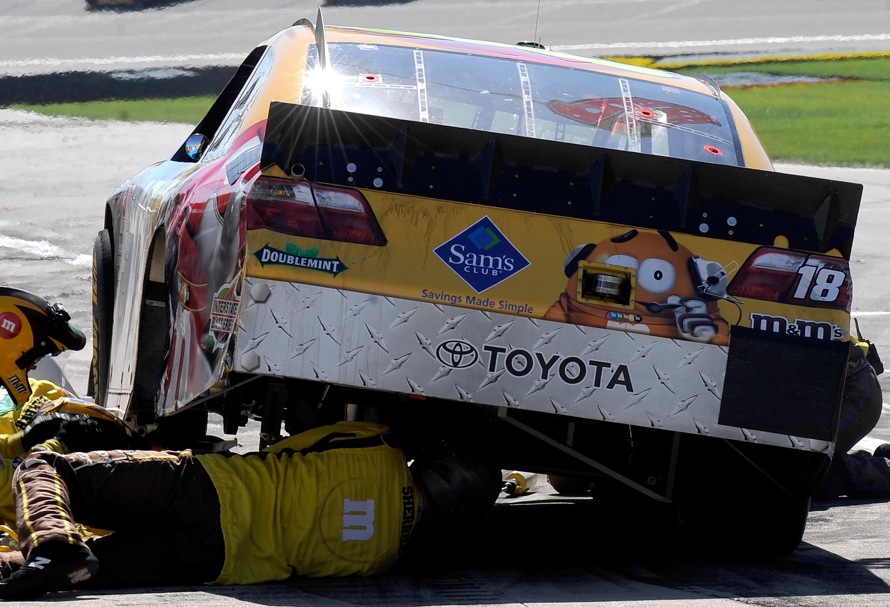 KANSAS CITY, KS - OCTOBER 03:  Crew members work on the car of Kyle Busch, driver of the #18 M&M's Toyota, during the NASCAR Sprint Cup Series Price Chopper 400 on October 3, 2010 in Kansas City, Kansas.  (Photo by Rusty Jarrett/Getty Images for NASCAR)