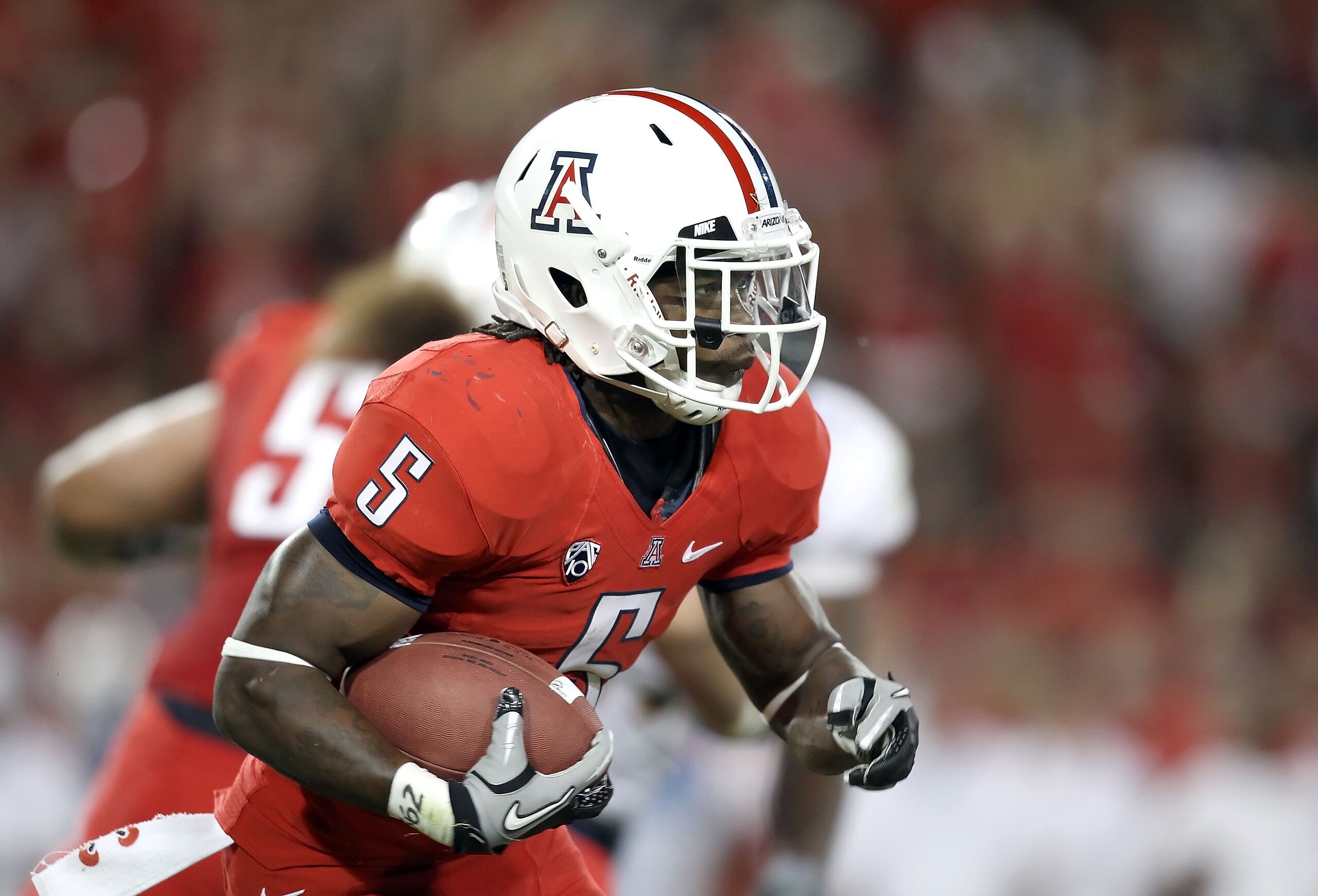 TUCSON, AZ - SEPTEMBER 25:  Runningback Nic Grigsby #5 of the Arizona Wildcats runs with the football during the college football game against the California Golden Bears at Arizona Stadium on September 25, 2010 in Tucson, Arizona.   The Wildcats defeated