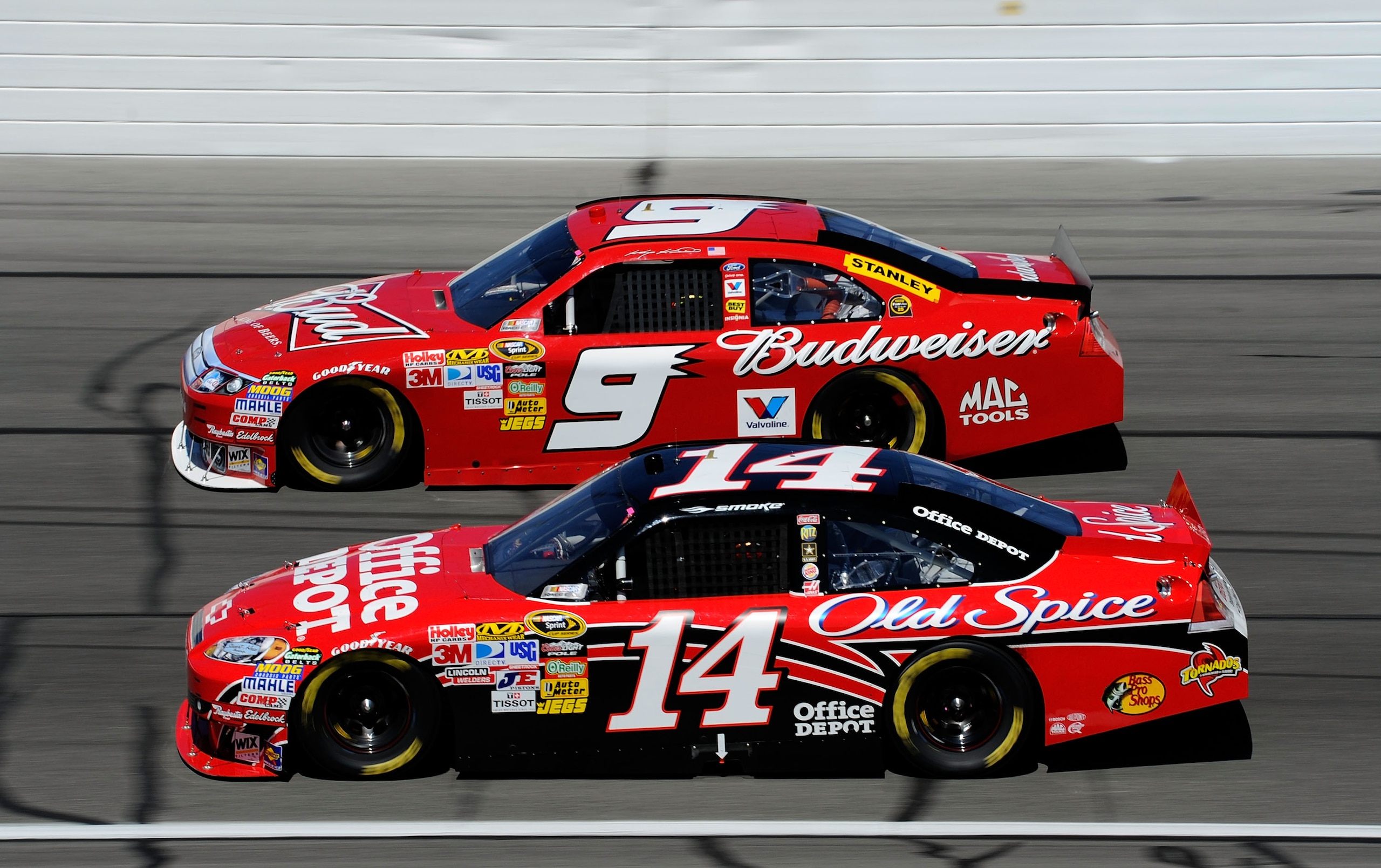 KANSAS CITY, KS - OCTOBER 03:  Tony Stewart, driver of the #14 Office Depot Chevrolet, races Kasey Kahne, driver of the #9 Budweiser Ford, during the NASCAR Sprint Cup Series Price Chopper 400 on October 3, 2010 in Kansas City, Kansas.  (Photo by John Har