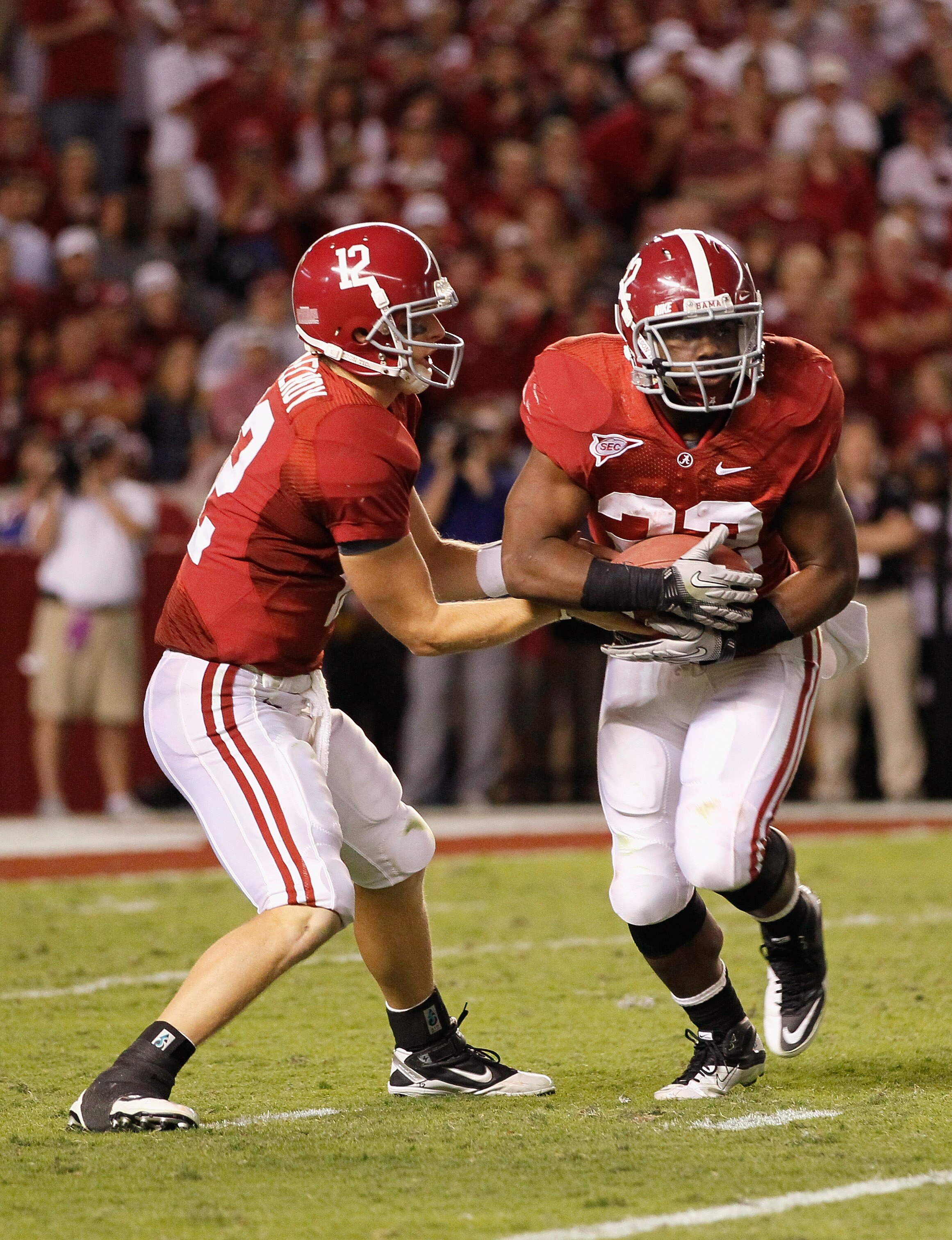 TUSCALOOSA, AL - OCTOBER 02:  Quarterback Greg McElroy #12 of the Alabama Crimson Tide hands the ball off to Mark Ingram #22 during the game against the Florida Gators at Bryant-Denny Stadium on October 2, 2010 in Tuscaloosa, Alabama.  (Photo by Kevin C.