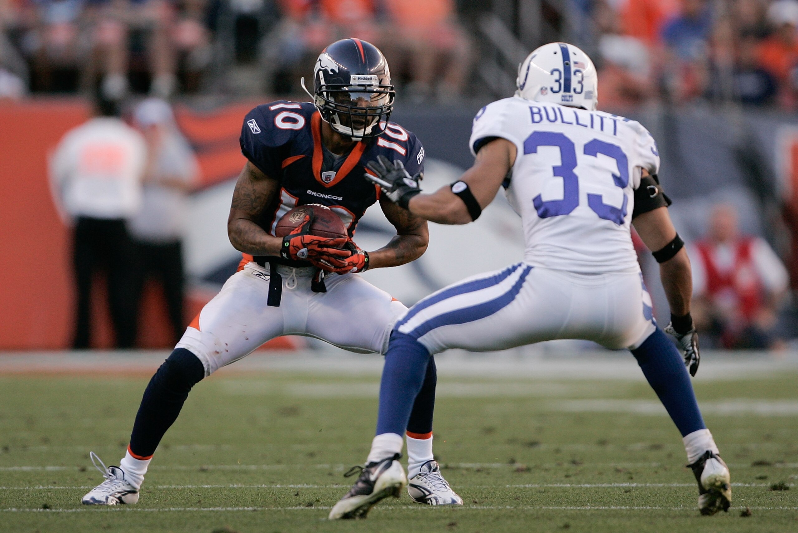 DENVER - SEPTEMBER 26:  Wide receiver Jabar Gaffney #10 of the Denver Broncos looks for extra yardage after making a catch in front of safety Melvin Bullitt #33 of the Indianapolis Colts during NFL action at INVESCO Field at Mile High on September 26, 201