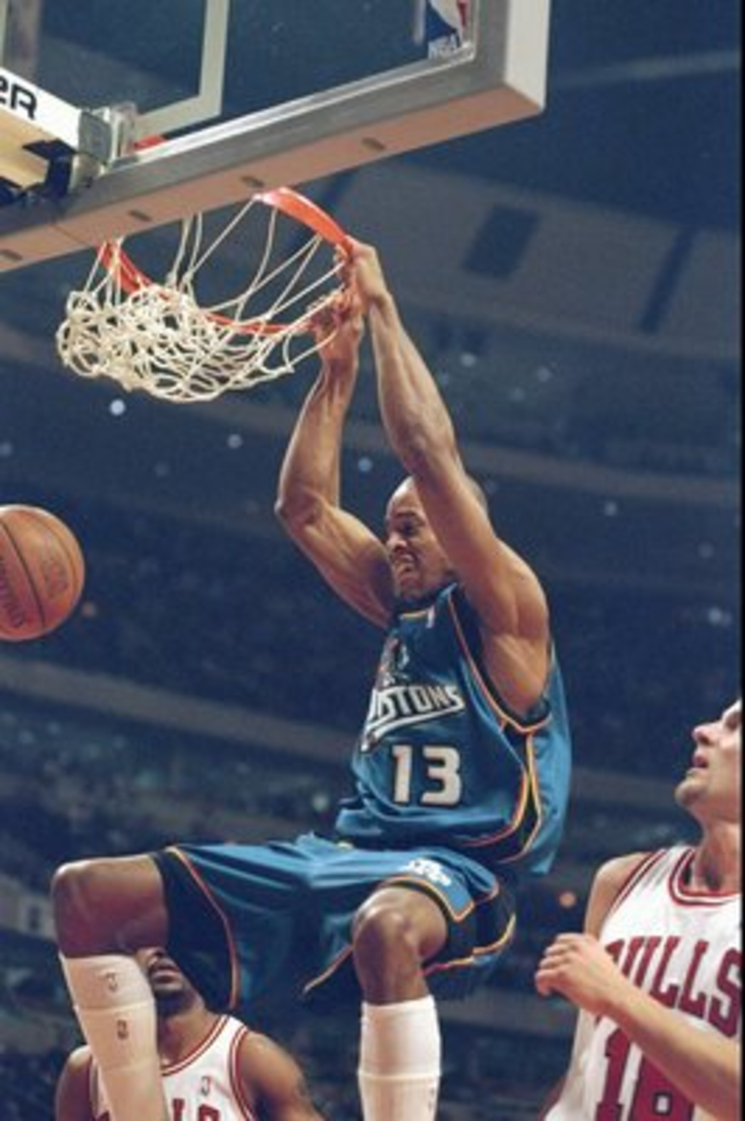 2 Mar 1999:  Jerome Williams #13 of the Detroit Pistons hanging on the rim after slam dunking the ball during the game against the Chicago Bulls at the United Center in Chicago, Illinois. The Pistons defeated the Bulls 108-78.   Mandatory Credit: Jonathan
