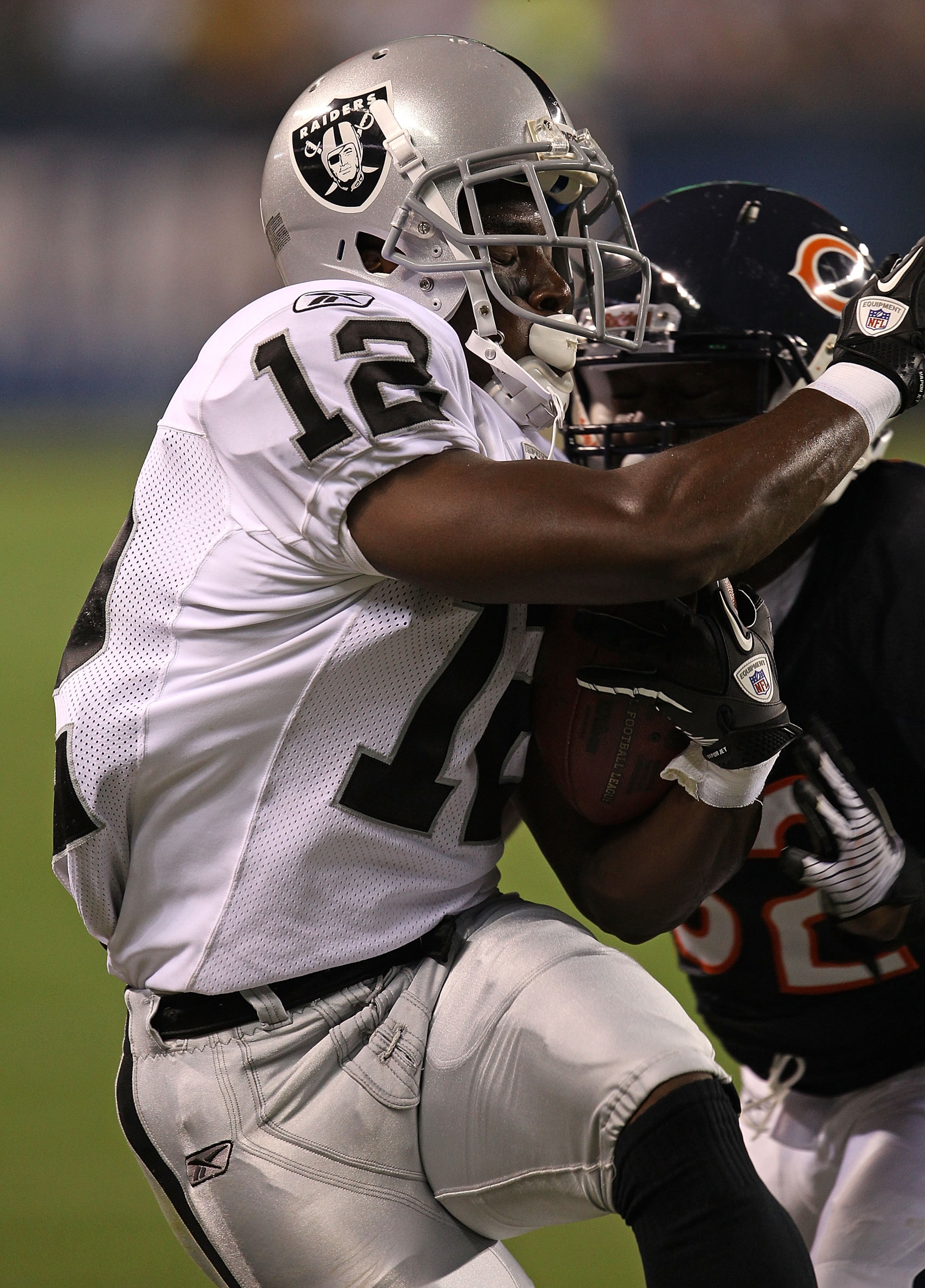 CHICAGO - AUGUST 21: Jacoby Ford #12 of the Oakland Raiders is hit by Kevin Malast #52 of the Chicago Bears during a preseason game at Soldier Field on August 21, 2010 in Chicago, Illinois. The Raiders defeated the Bears 32-17. (Photo by Jonathan Daniel/G CHICAGO - AUGUST 21: Jacoby Ford #12 of the Oakland Raiders is hit by Kevin Malast #52 of the Chicago Bears during a preseason game at Soldier Field on August 21, 2010 in Chicago, Illinois. The Raiders defeated the Bears 32-17. (Photo by Jonathan Daniel/G