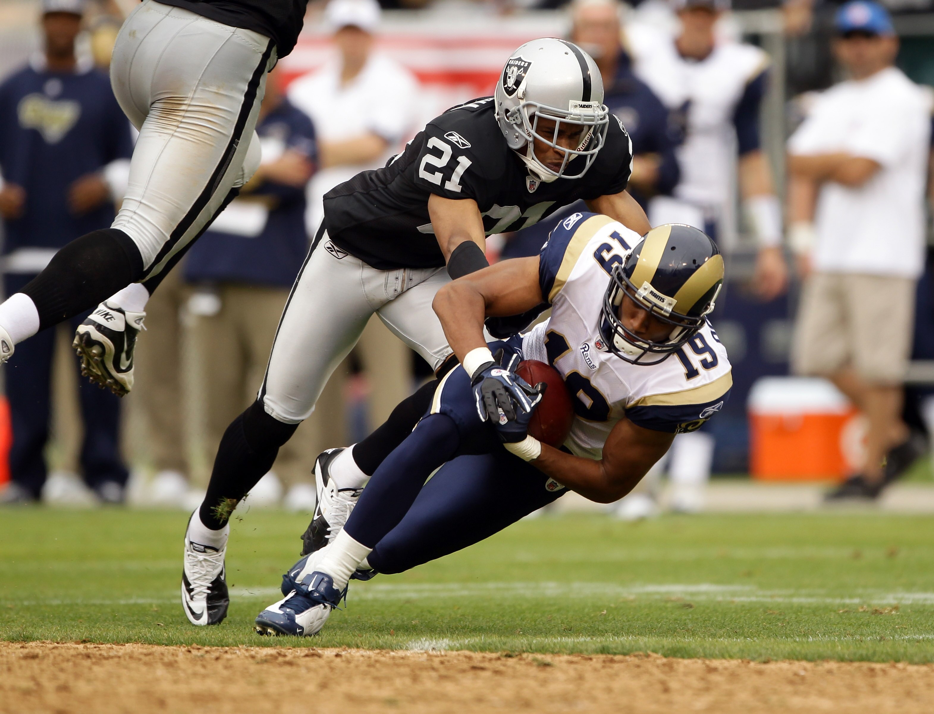 OAKLAND, CA - SEPTEMBER 19:  Laurent Robinson #19 of the St. Louis Rams is tackled by Nnamdi Asomugha #21 of the Oakland Raiders at the Oakland-Alameda County Coliseum on September 19, 2010 in Oakland, California.  (Photo by Ezra Shaw/Getty Images)