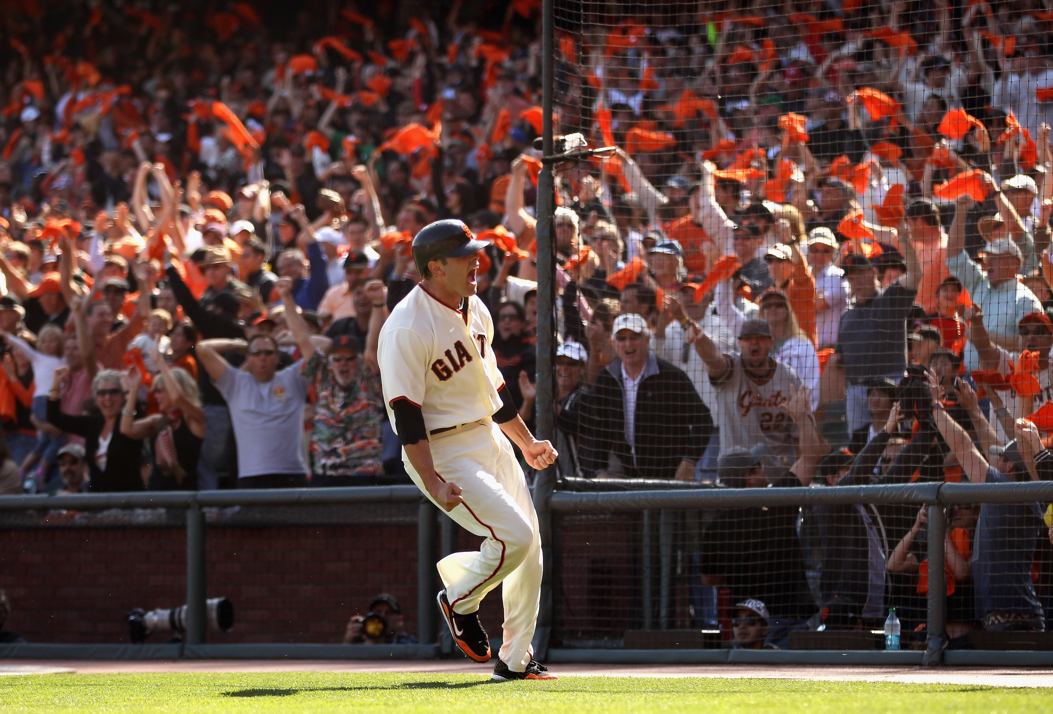 SAN FRANCISCO - OCTOBER 03:  Freddy Sanchez #21 of the San Francisco Giants celebrates after he scored on a double to give the Giants a 2-0 lead in the third inning of their game against the San Diego Padres at AT&T Park on October 3, 2010 in San Francisc