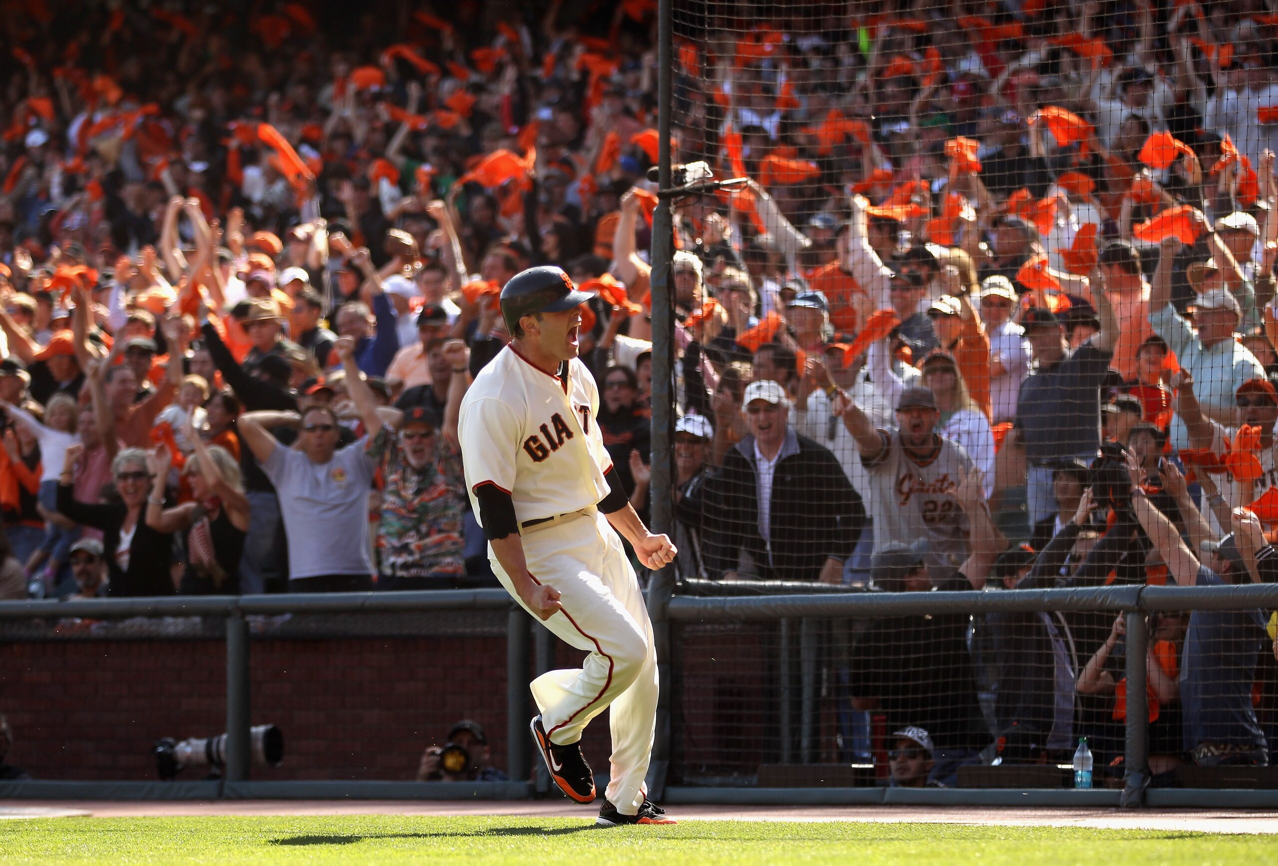 SAN FRANCISCO - OCTOBER 03:  Freddy Sanchez #21 of the San Francisco Giants celebrates after he scored on a double to give the Giants a 2-0 lead in the third inning of their game against the San Diego Padres at AT&T Park on October 3, 2010 in San Francisc