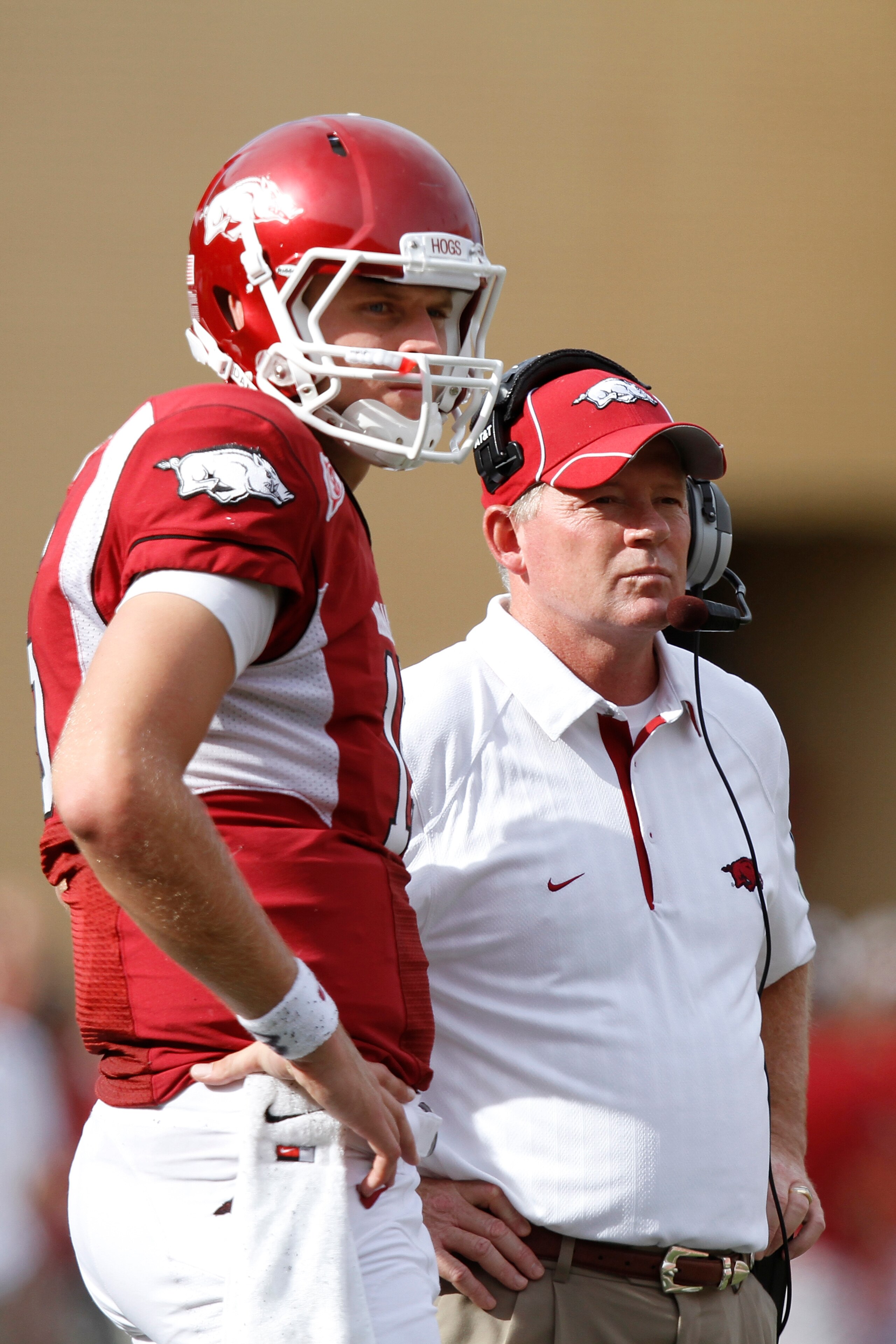 FAYETTEVILLE - SEPTEMBER 25: Head coach Bobby Petrino and quarterback Ryan Mallett #15 of the Arkansas Razorbacks look on during the first half against the Alabama Crimson Tide at Donald W. Reynolds Razorback Stadium on September 25, 2010 in Fayetteville,