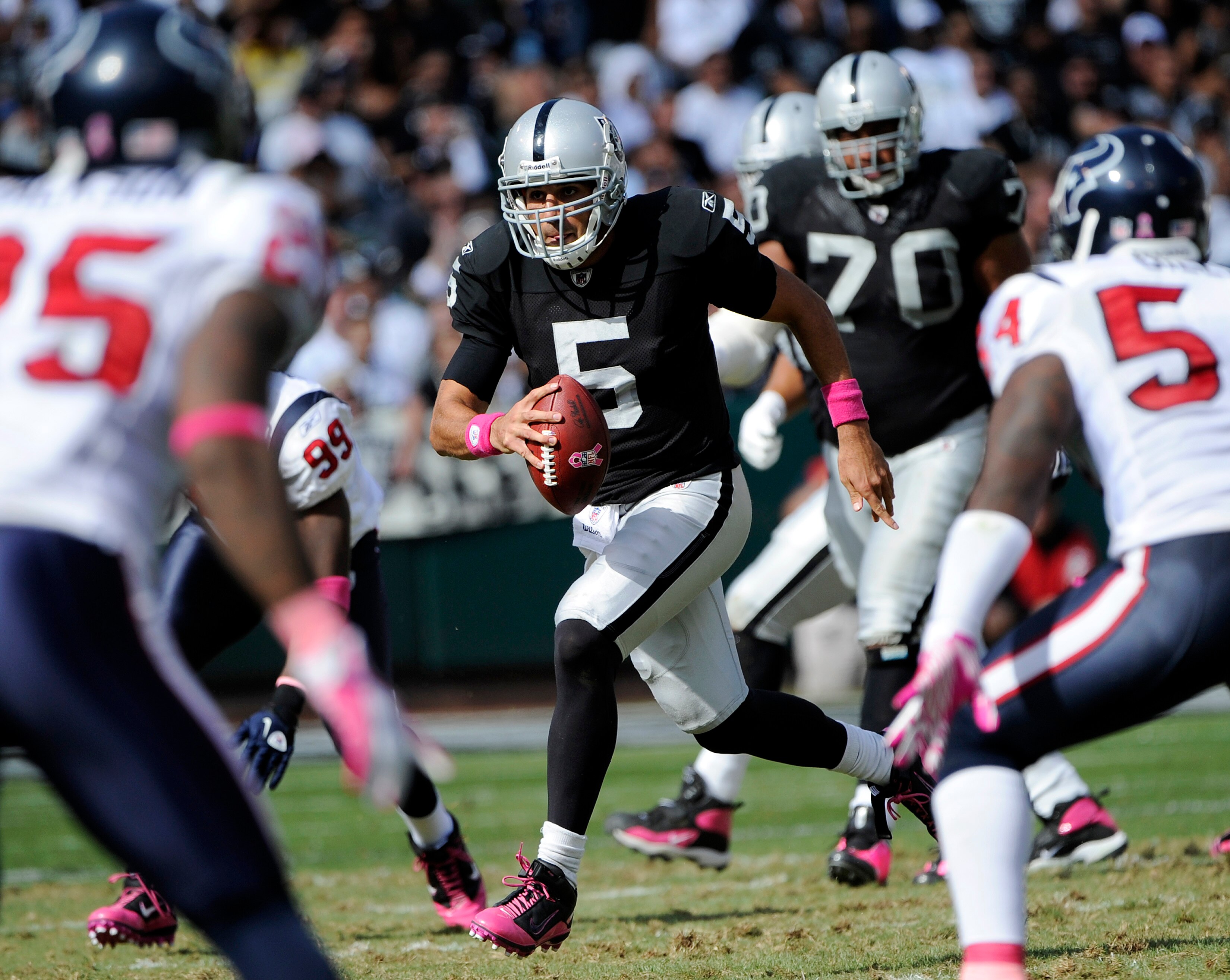 OAKLAND, CA - OCTOBER 3:  Quarterback Bruce Gradkowski #5 of the Oakland Raiders scrambles with the ball for a first down against the Houston Texans during an NFL football game October 3, 2010 at The Oakland-Alameda County Coliseum in Oakland, California.