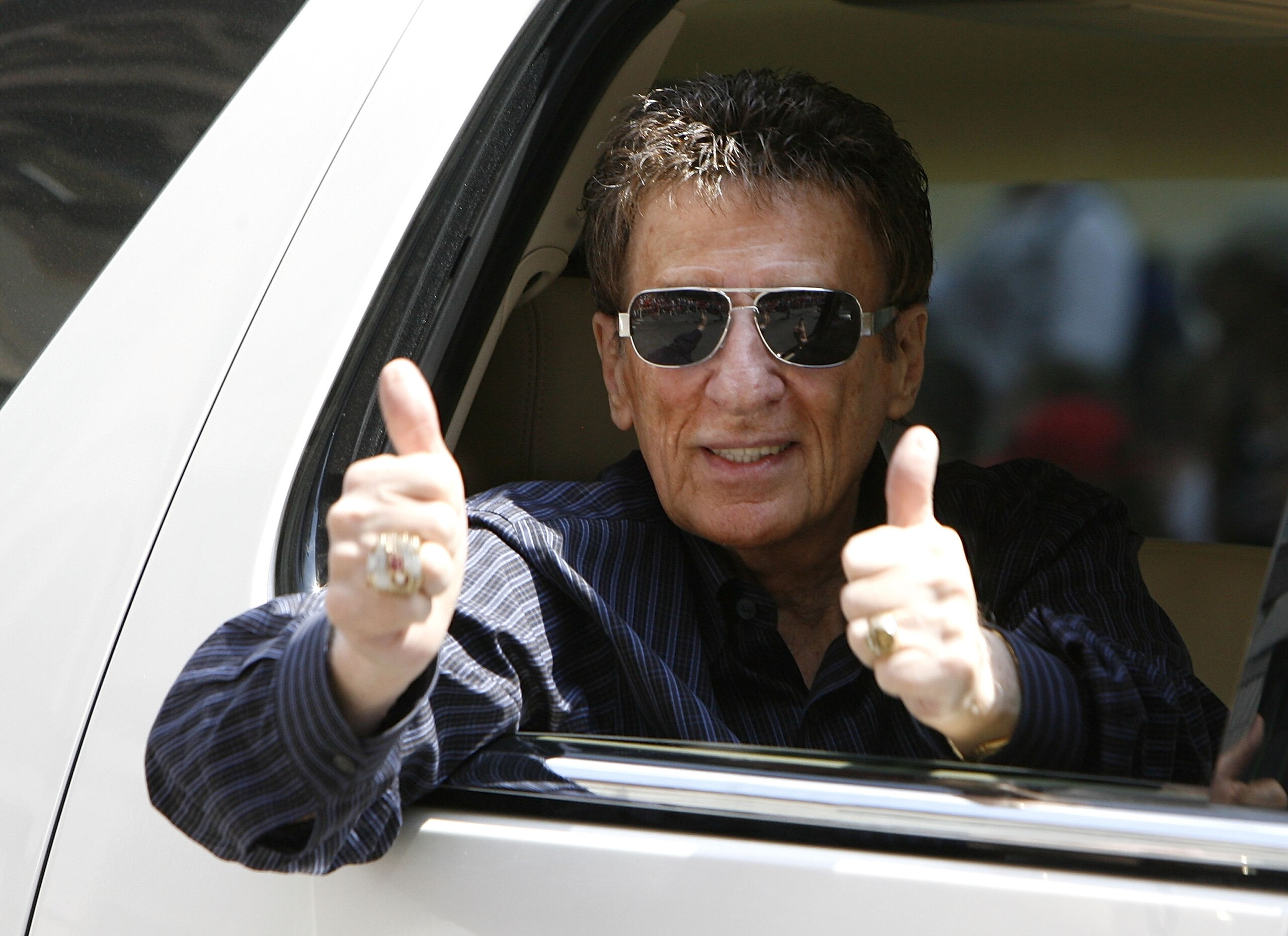 DETROIT - JUNE 06: Mike Illitch owner of the Detroit Red Wings reacts to fans during a parade to celebrate winning the 2008 Stanley Cup on June 6, 2008 in Detroit, Michigan.  (Photo by Gregory Shamus/Getty Images)