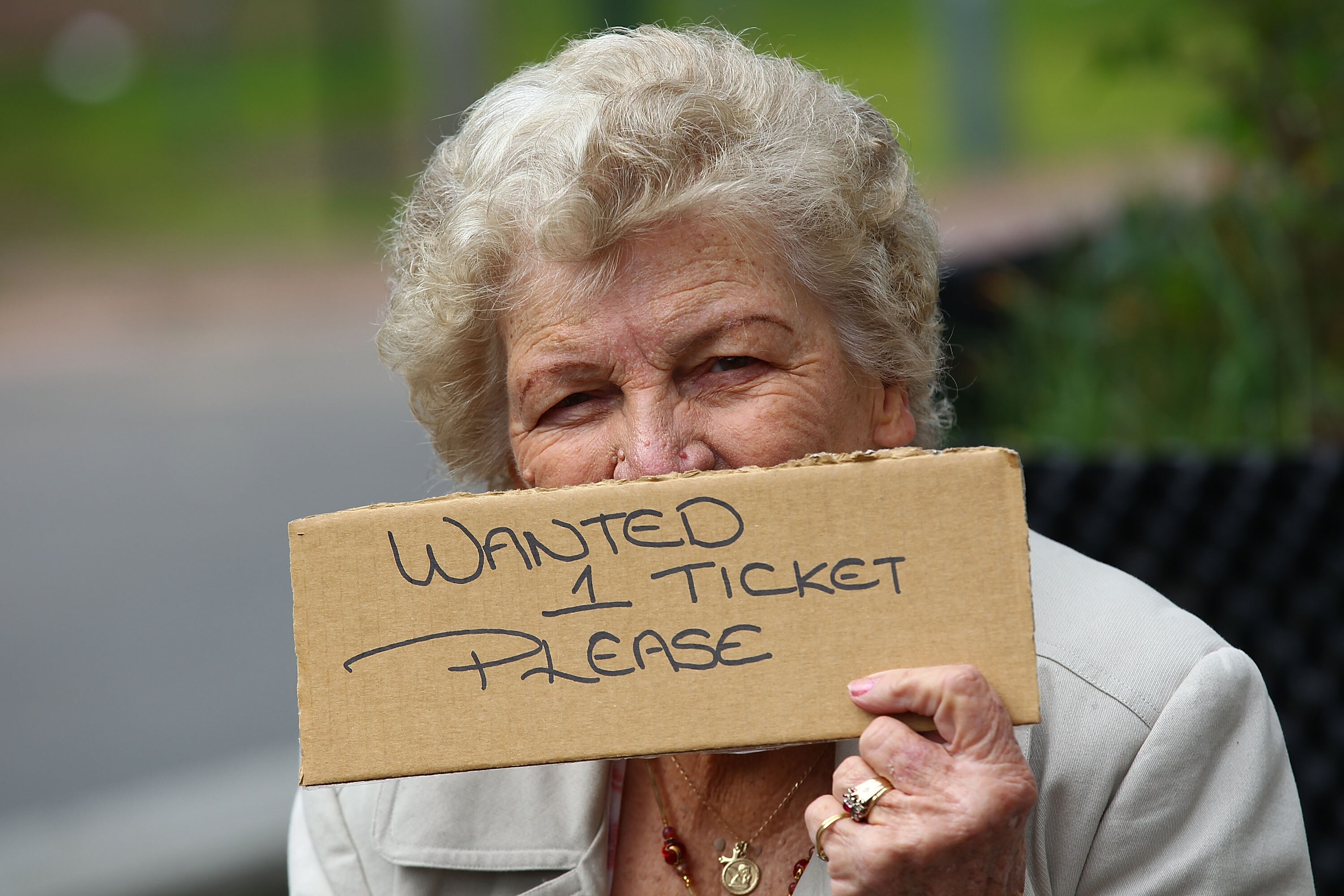 MELBOURNE, AUSTRALIA - SEPTEMBER 25:  A football fan holds a sign requesting match tickets prior to the AFL Grand Final match between the Collingwood Magpies and the St Kilda Saints at Melbourne Cricket Ground on September 25, 2010 in Melbourne, Australia