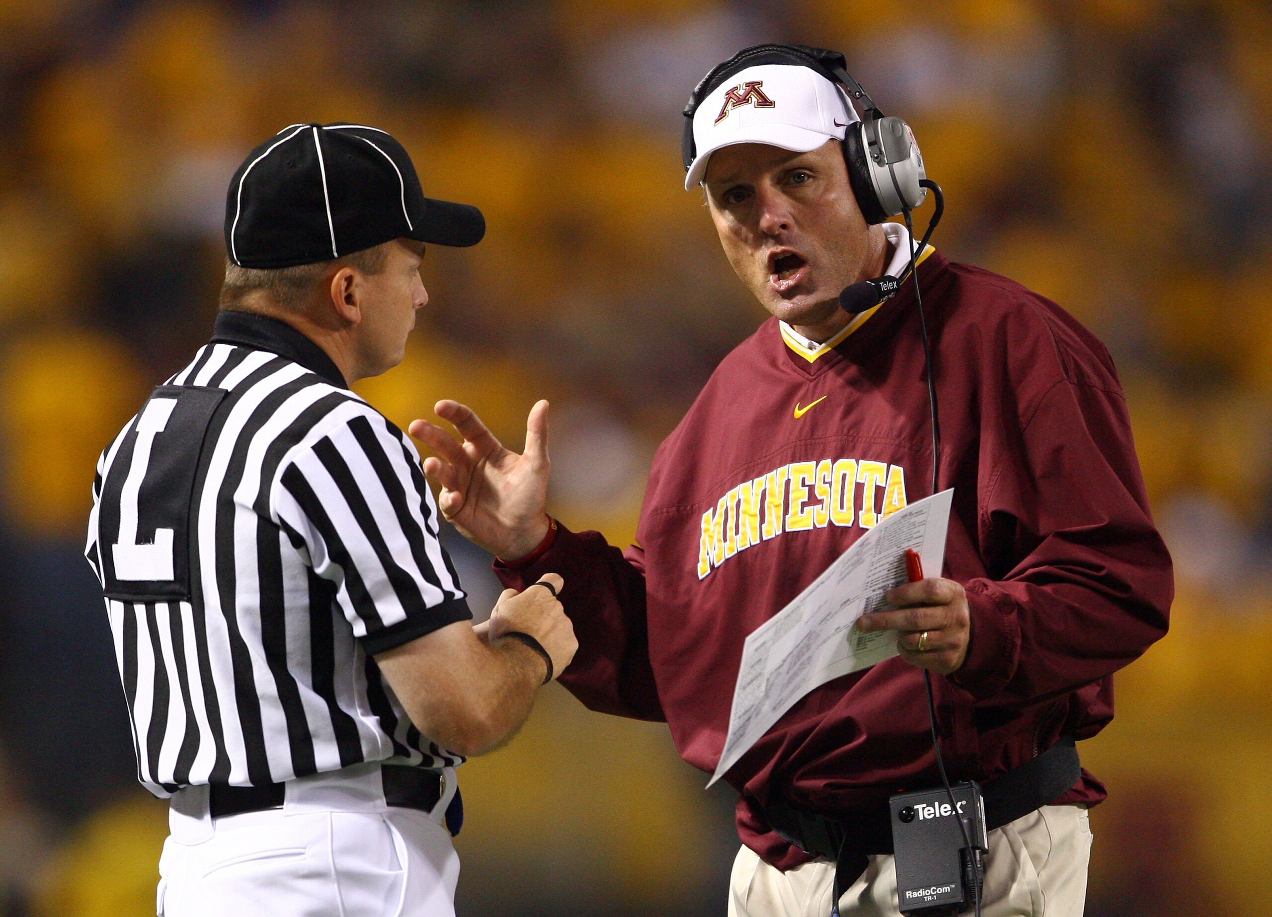 MINNEAPOLIS - SEPTEMBER 13:  Minnesota Golden Gophers' head coach Tim Brewster talks with an official during the game against the Montana State Bobcats at the Metrodome on September 13, 2008 in Minneapolis, Minnesota. Minnesota defeated Montana State 35-2